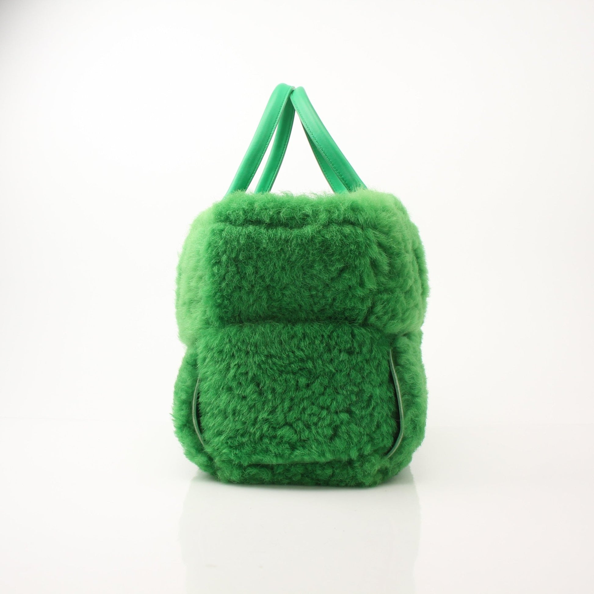 Green Bottega Veneta Arco Tote handbag with structured design, featuring smooth leather and top handles, displayed on a neutral background.