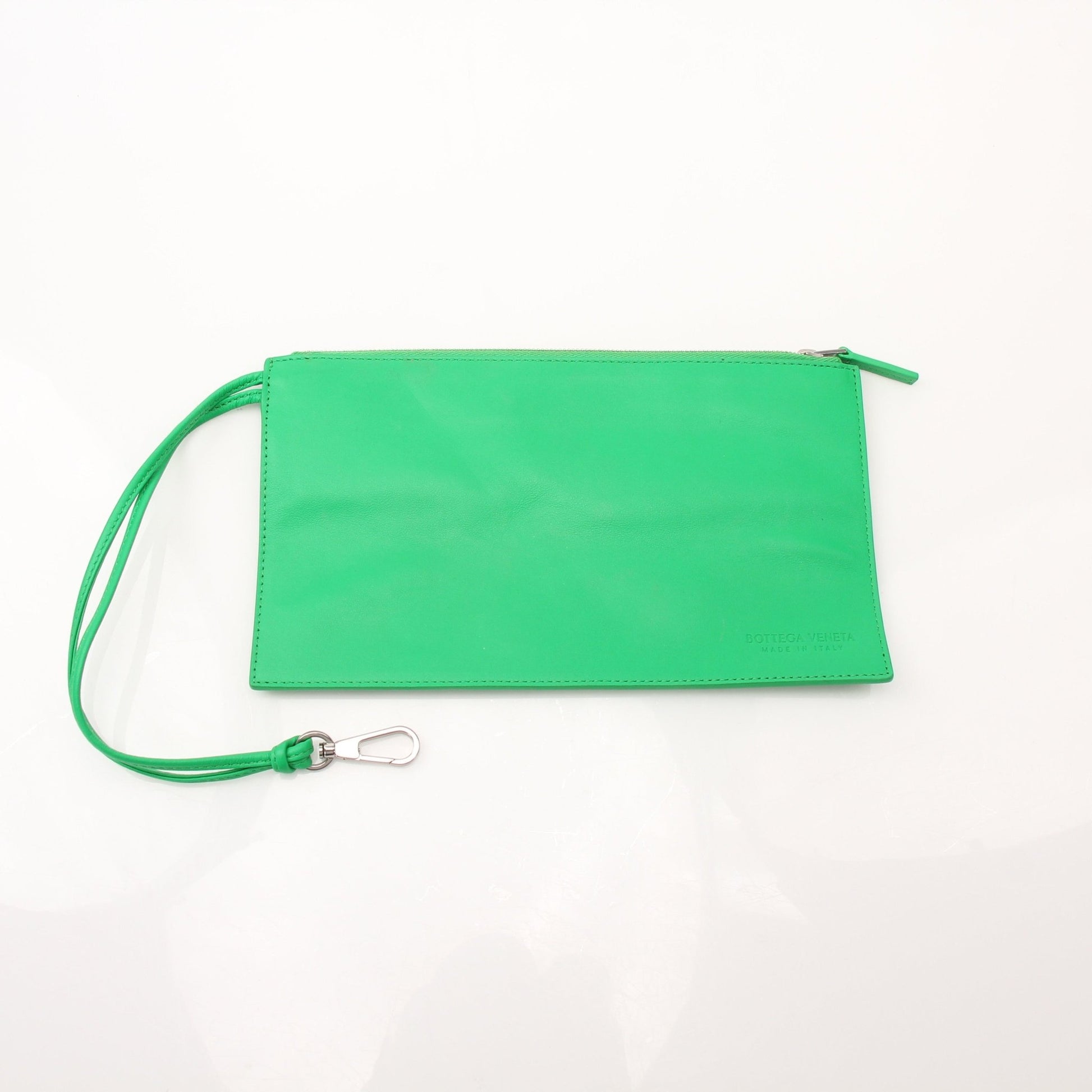 Green Bottega Veneta Arco Tote handbag with structured design and top handles, displayed with a textured leather finish.