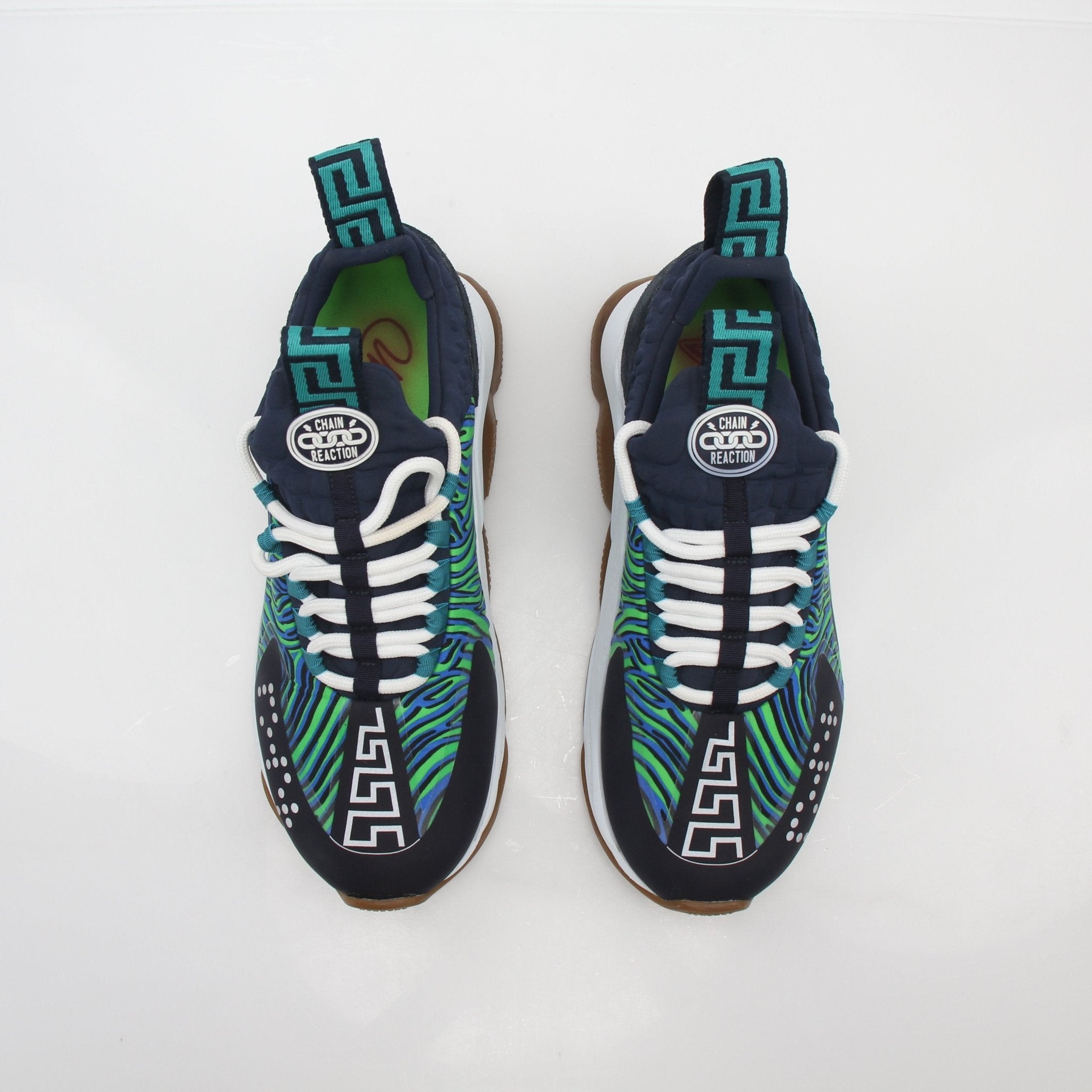 Gold & Beyond Versace Chain Reaction Sneakers in blue and green with intricate chain pattern on stylish shoe design.
