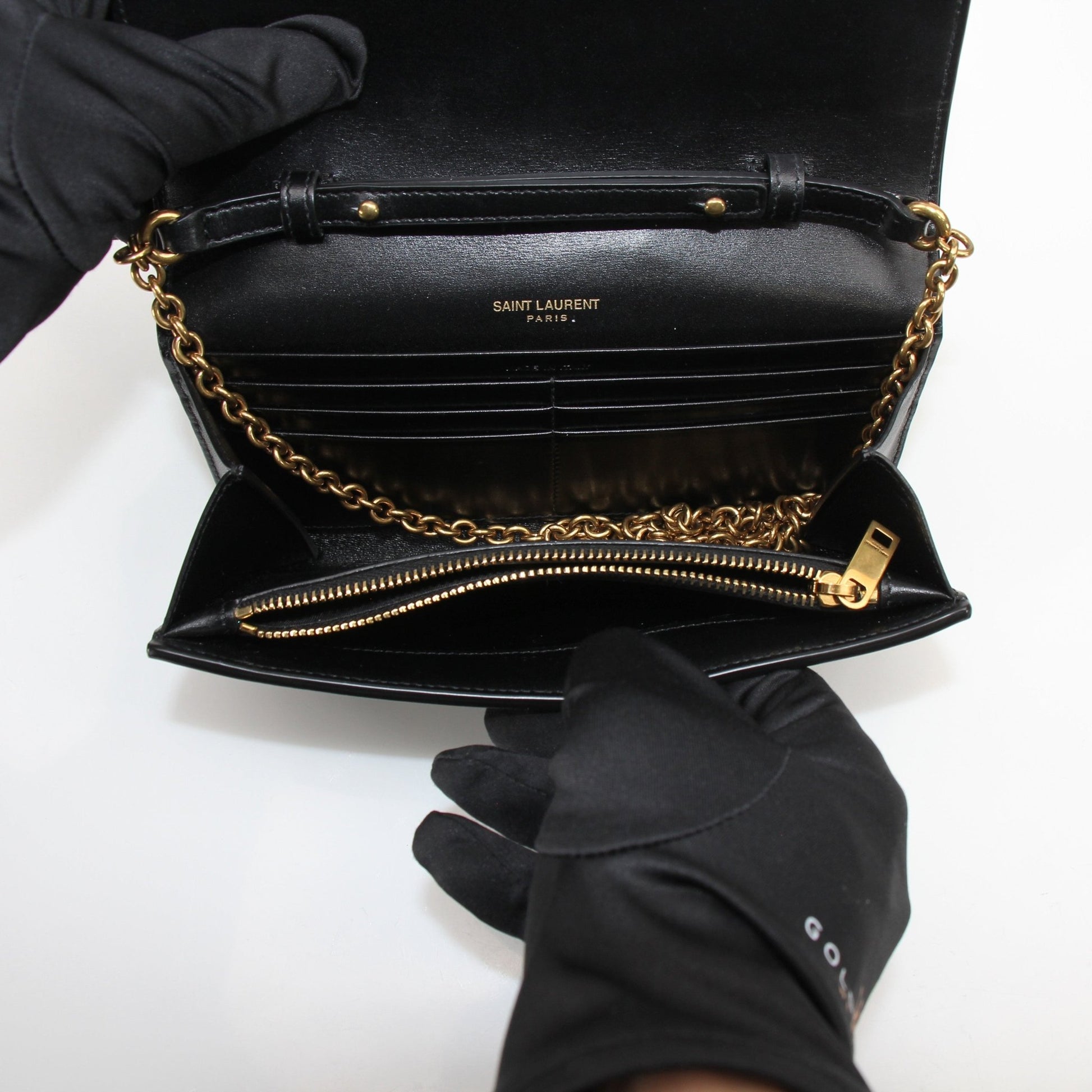 Gold & Beyond Saint Laurent Wallet on Chain in black leather with gold hardware, featuring multiple card slots and a chain strap.