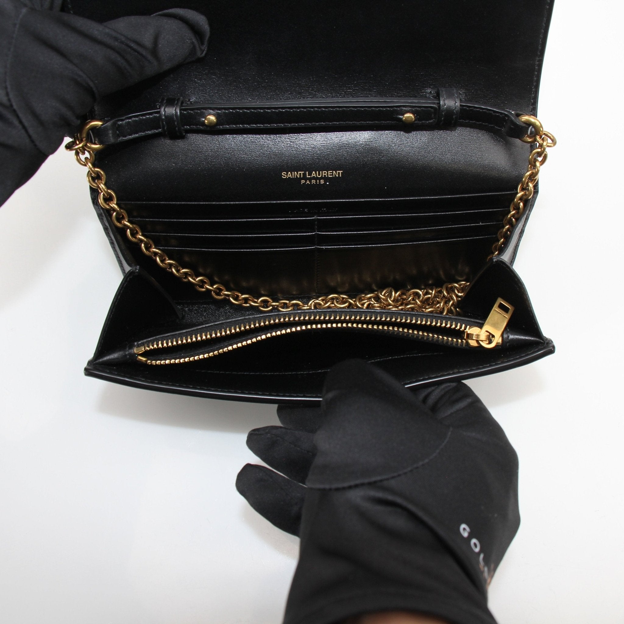 Gold & Beyond Saint Laurent Wallet on Chain in black leather with gold hardware, featuring multiple card slots and a chain strap.