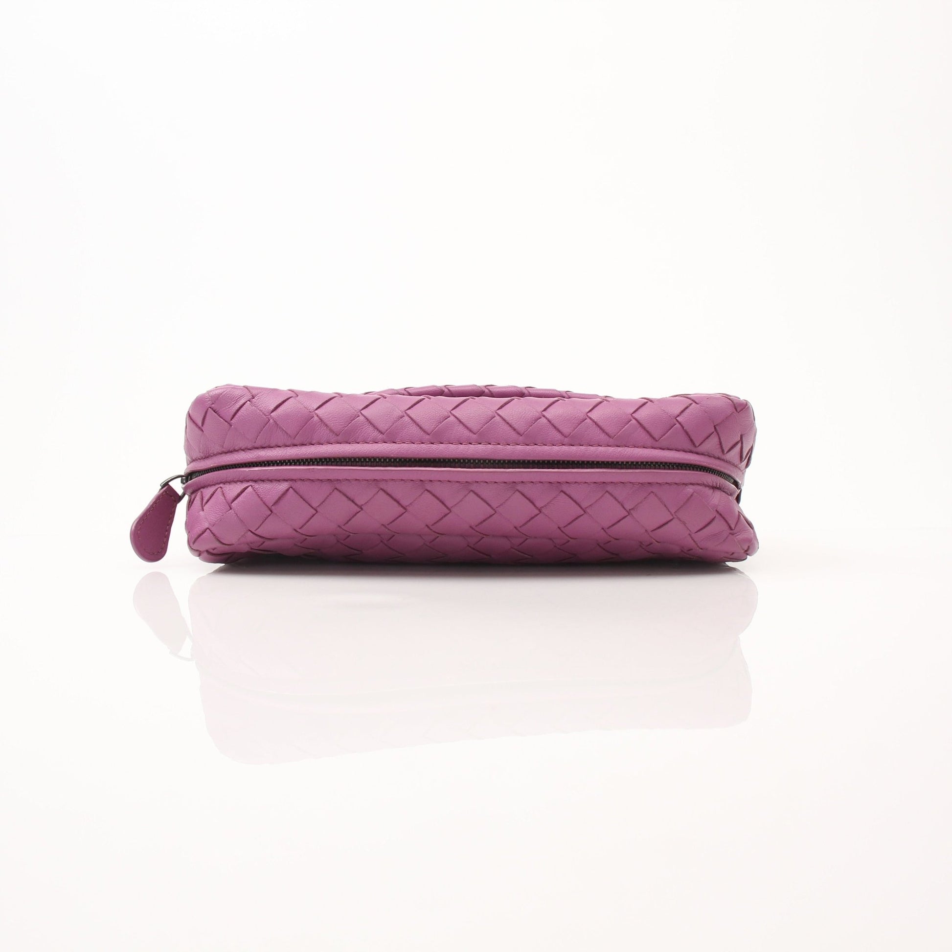 Bottega Veneta expandable chain flap handbag with gold hardware and woven leather texture, carried by hand.