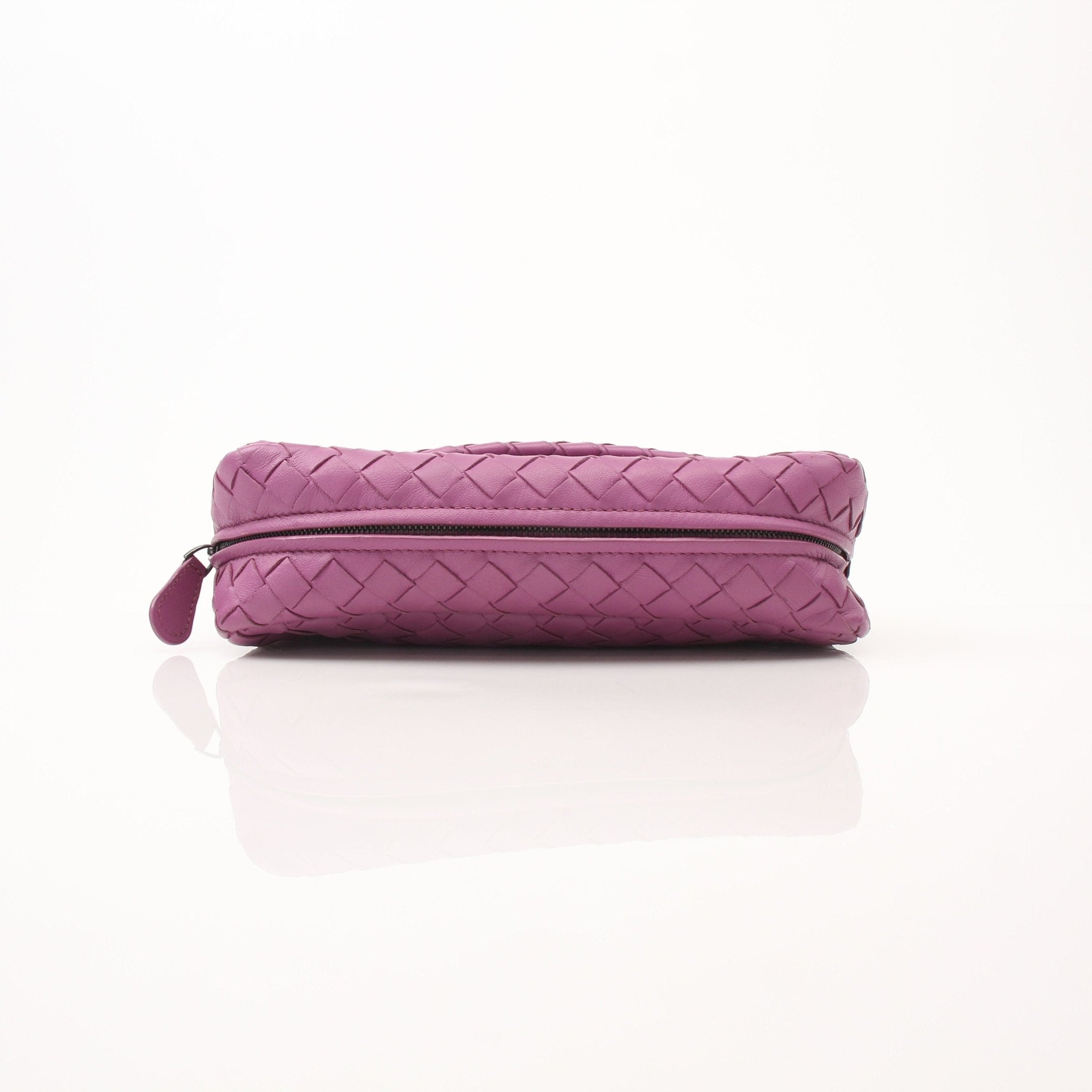 Bottega Veneta expandable chain flap handbag with gold hardware and woven leather texture, carried by hand.