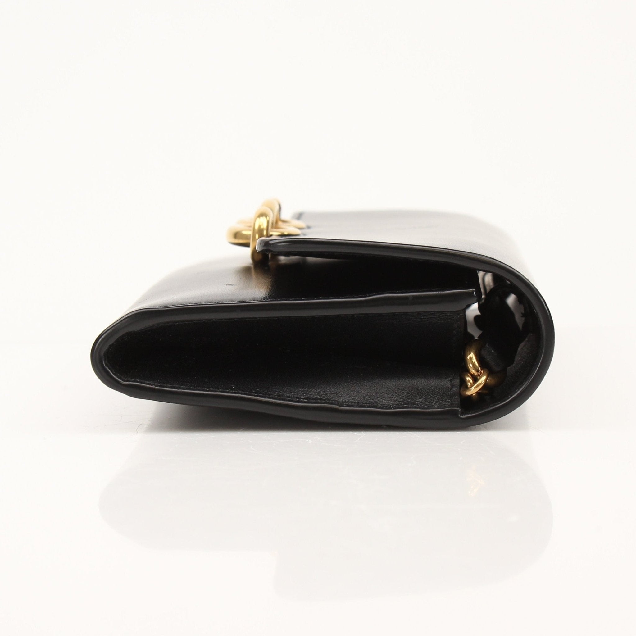 Gold & Beyond Saint Laurent Wallet on Chain with gold-tone hardware and sleek leather design.