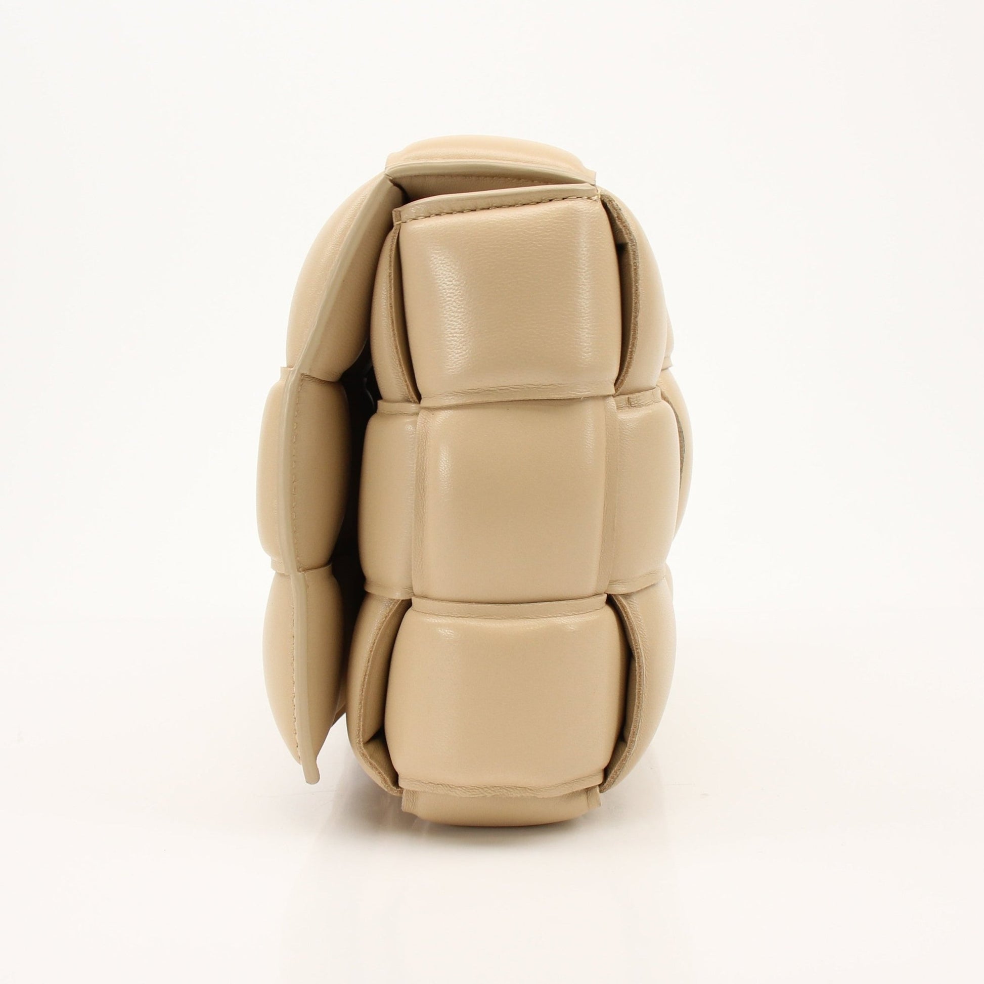 Gold & Beyond padded Bottega Veneta Cassette handbag with quilted leather design and adjustable strap, stylish and luxurious accessory.