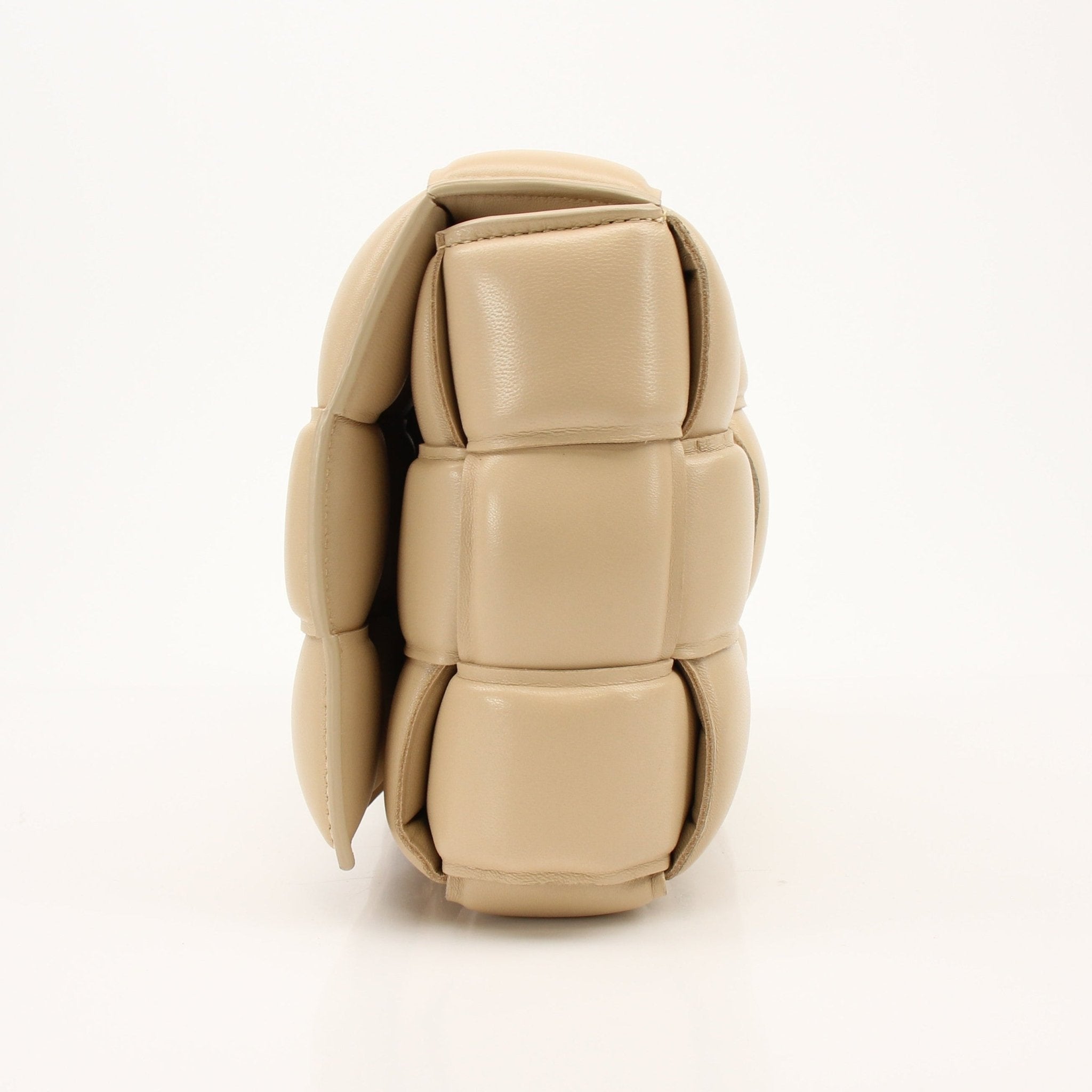 Gold & Beyond padded Bottega Veneta Cassette handbag with quilted leather design and adjustable strap, stylish and luxurious accessory.