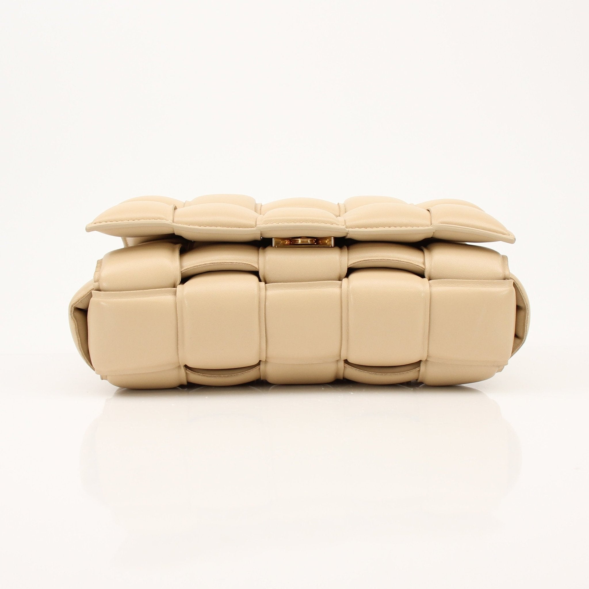 Gold & Beyond padded Bottega Veneta Cassette handbag with quilted leather and signature design, featuring chain strap and sleek style.