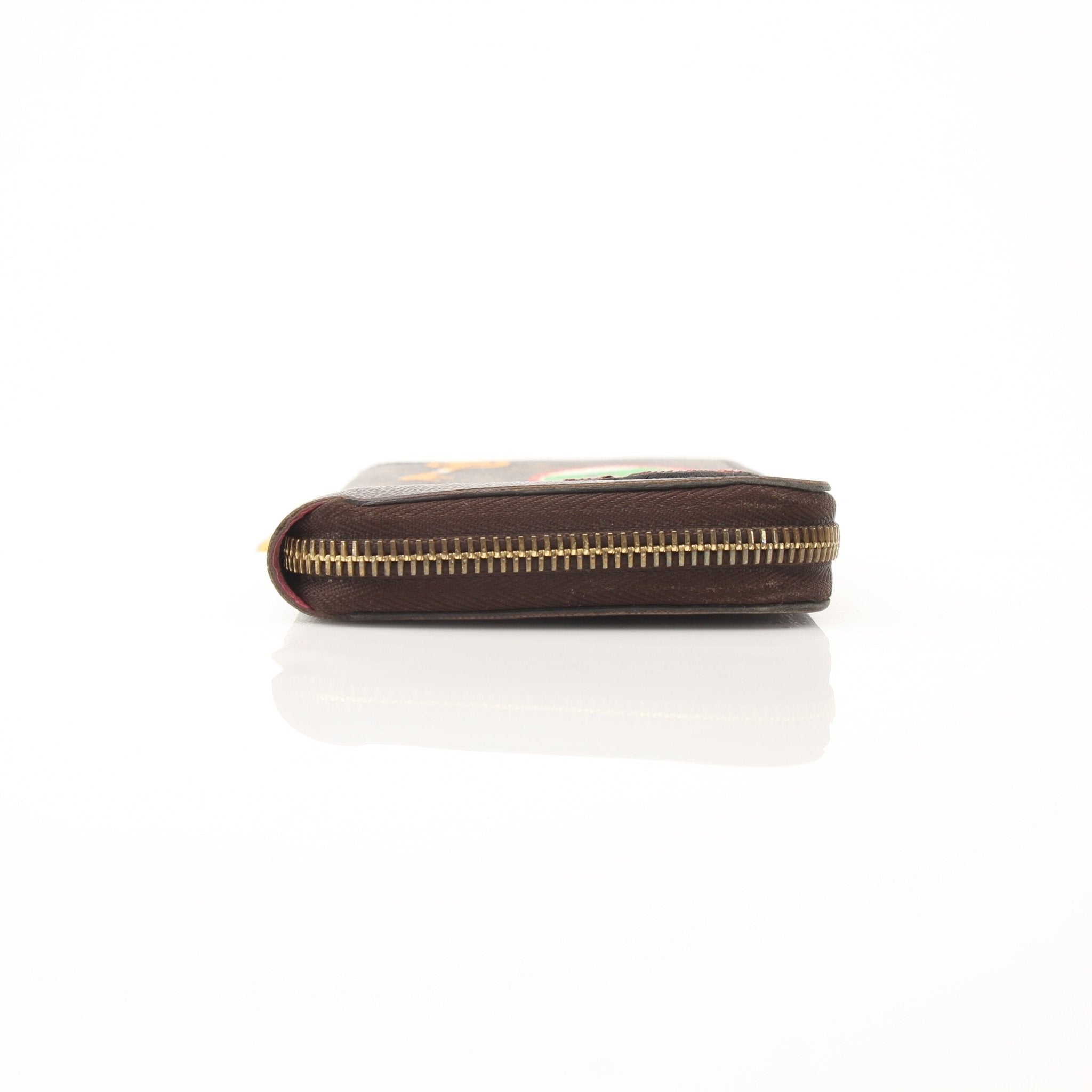 Louis Vuitton LV Stories Zippy Wallet with gold accents and textured leather, featuring multiple card slots and a zipper closure.