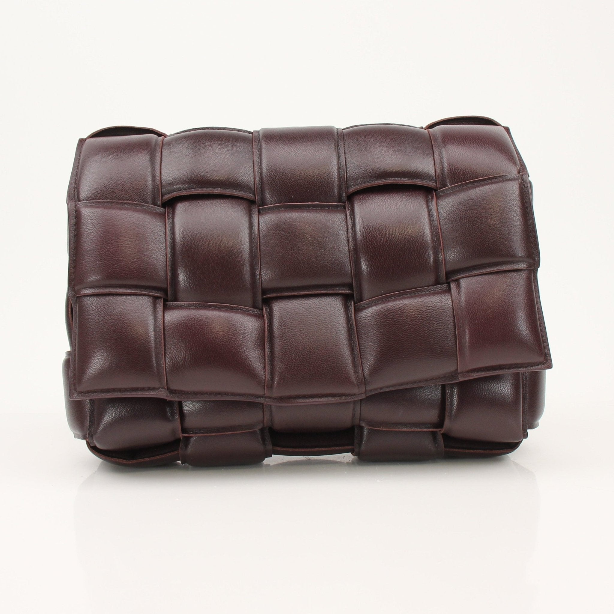 Gold & Beyond padded Bottega Veneta Cassette handbag with signature woven leather design and sleek style.