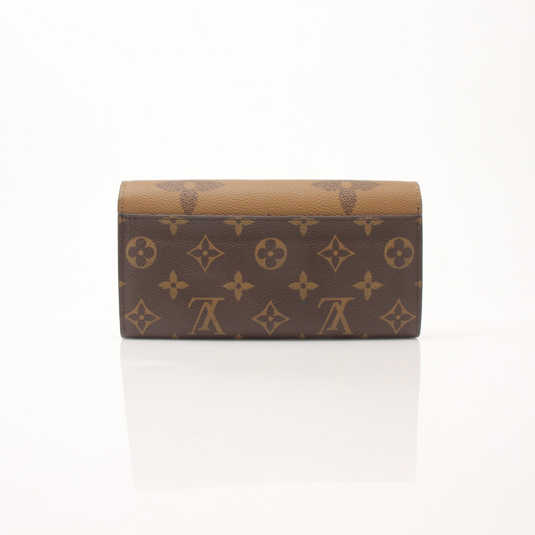 Louis Vuitton reverse monogram wallet with gold accents, featuring multiple card slots and a sleek, compact design.