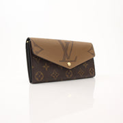 Louis Vuitton Reverse Monogram Wallet with gold accents, showcasing the signature monogram pattern and compact design.