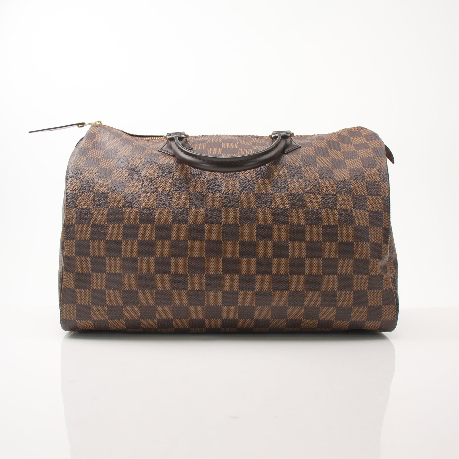 Louis Vuitton Speedy 35 handbag in classic monogram canvas with leather handles, displayed on a neutral background.