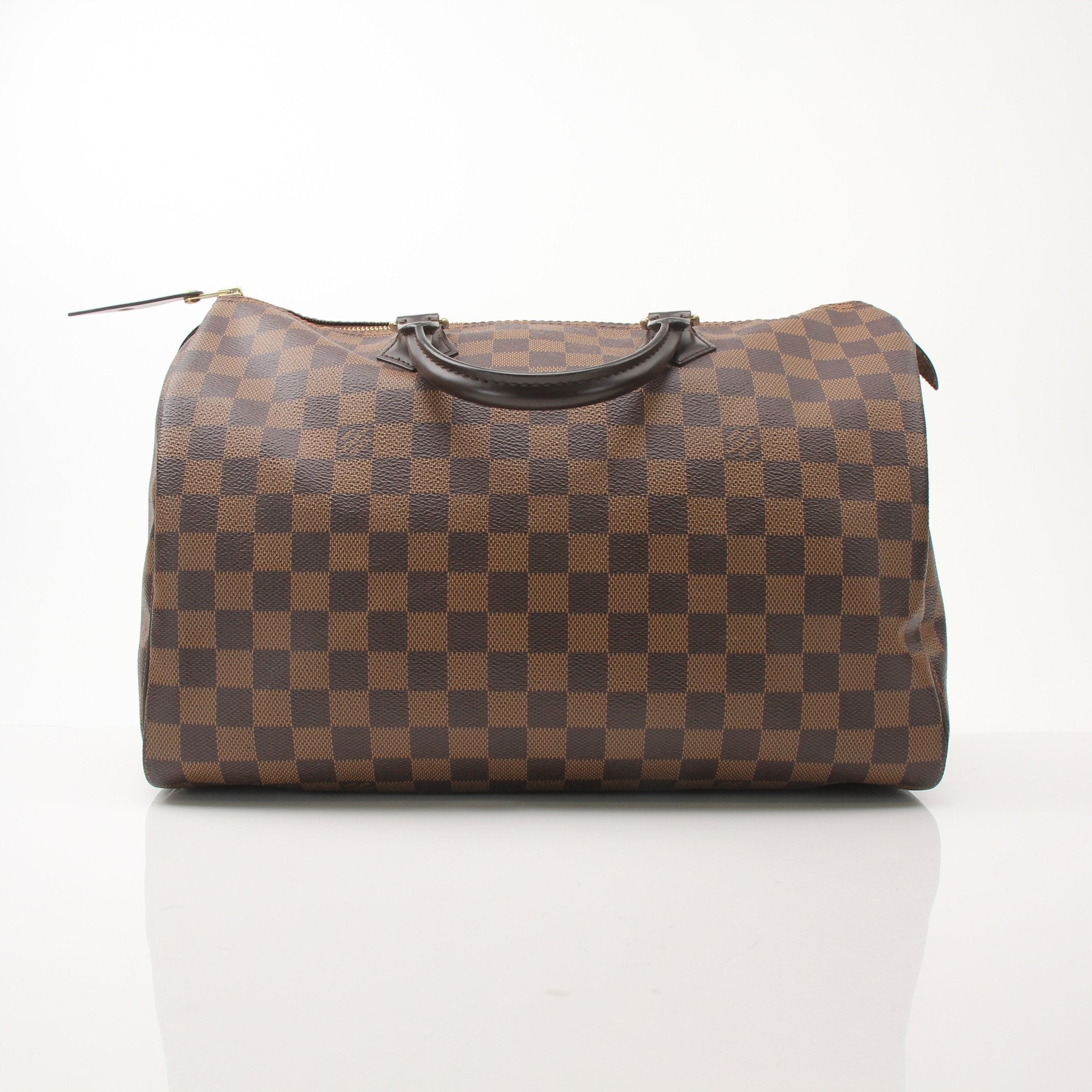 Louis Vuitton Speedy 35 handbag in classic monogram canvas with leather handles, displayed on a neutral background.