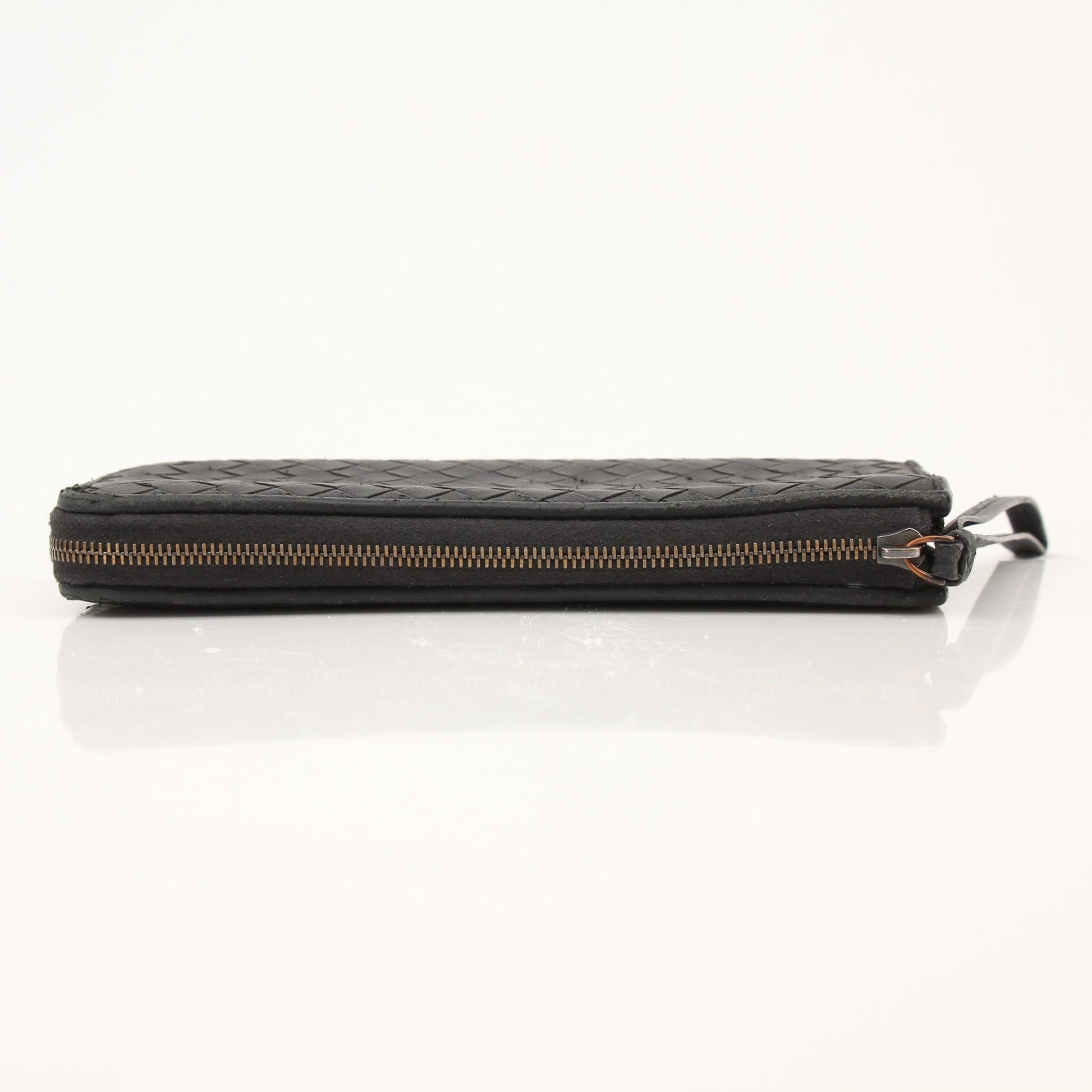 Black Bottega Veneta Intrecciato leather wallet with woven design, featuring a sleek, compact style and gold-tone logo detail.