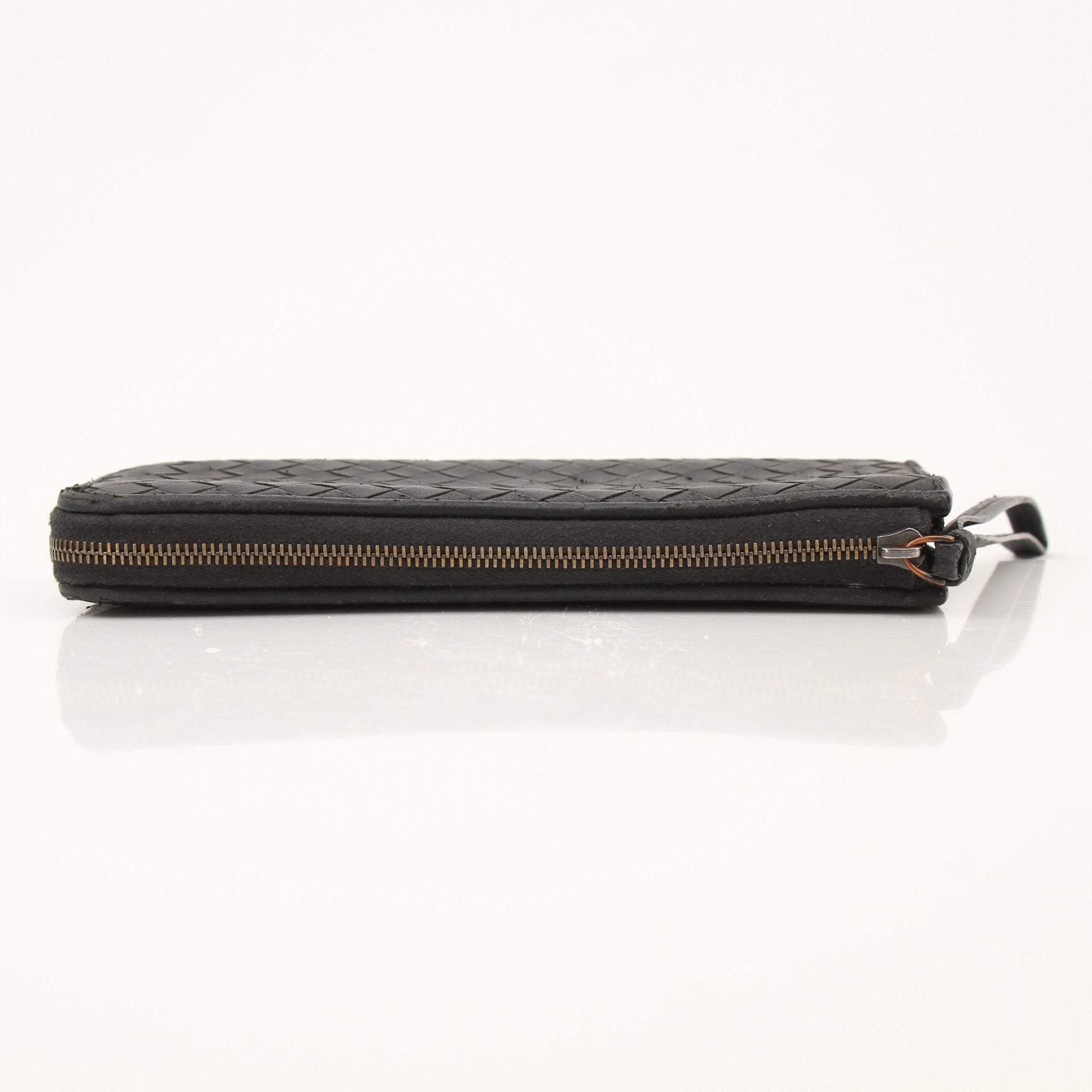 Black Bottega Veneta Intrecciato leather wallet with woven design, featuring a sleek, compact style and gold-tone logo detail.