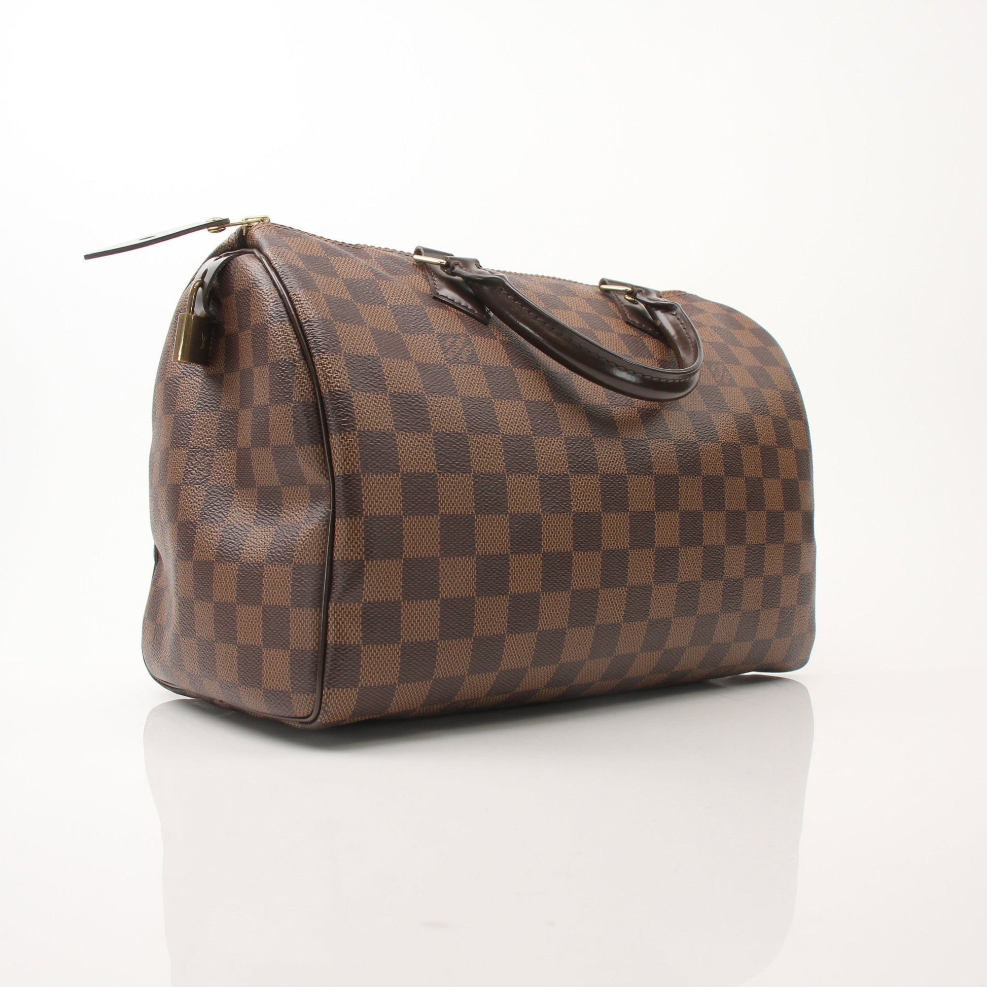 Louis Vuitton Speedy 30 handbag in classic monogram canvas with leather handles and gold-tone hardware on a neutral background
