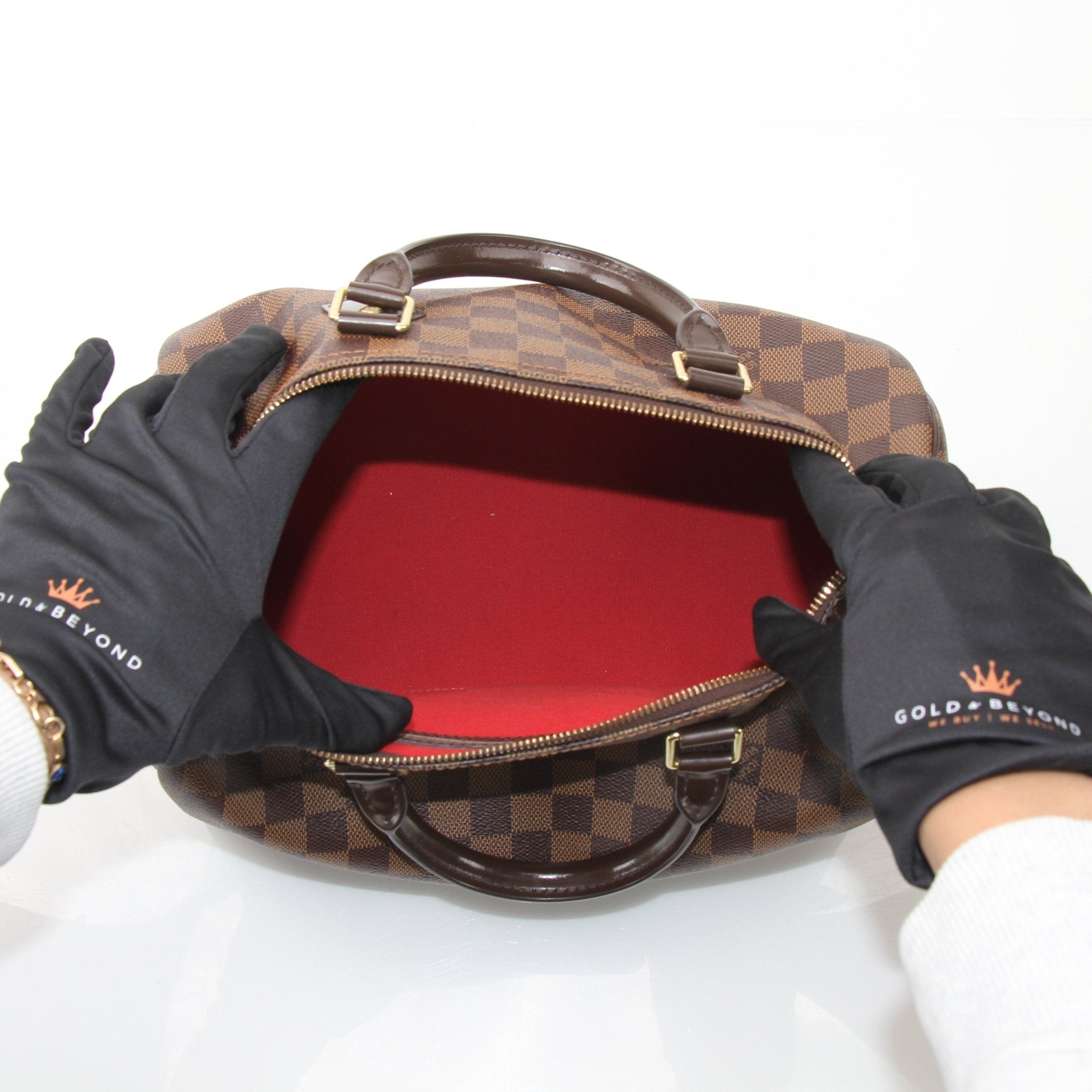 Louis Vuitton Speedy 30 handbag with gold-tone hardware and monogram canvas, displayed on a neutral background.