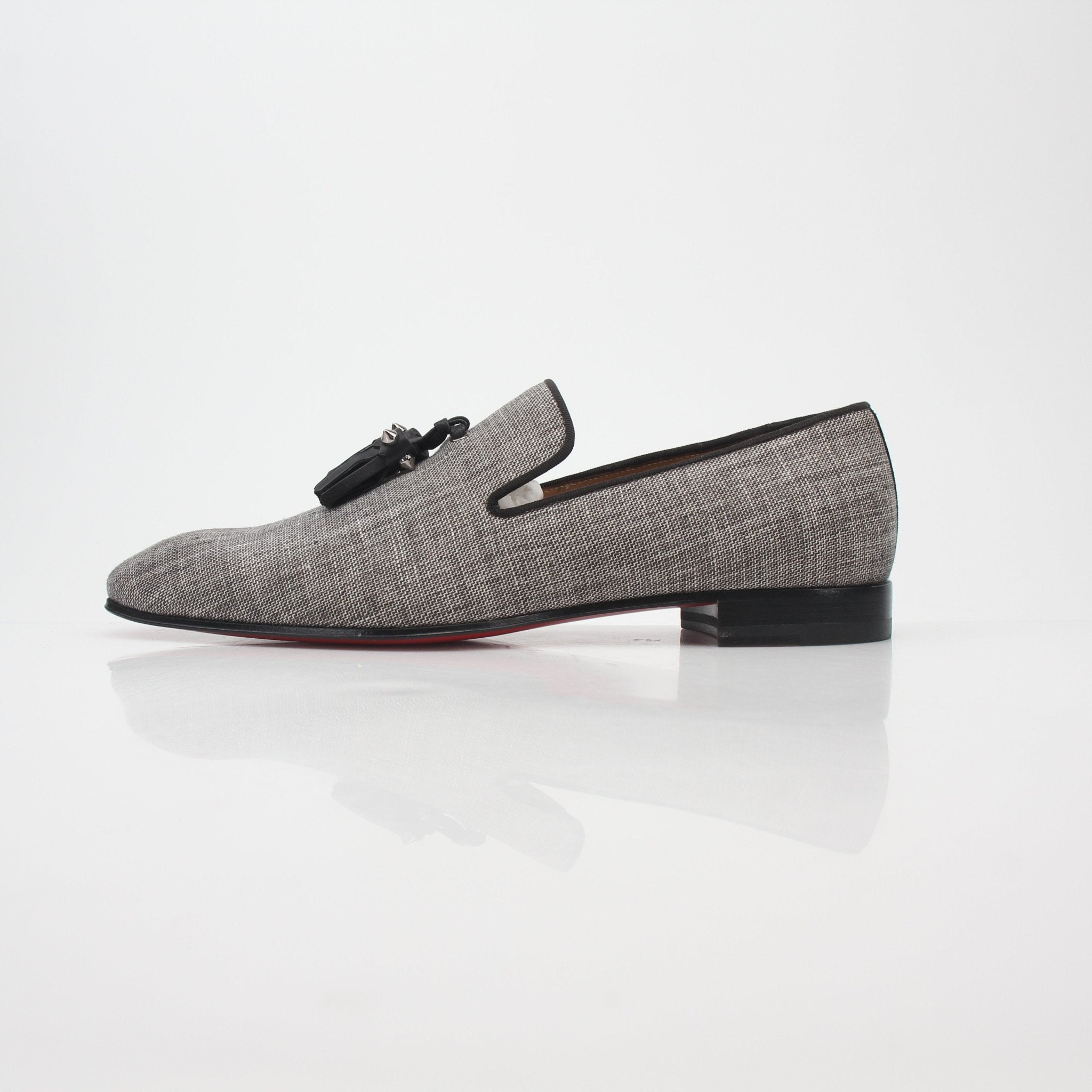 Christian Louboutin gray Dandelion Spikes tassel loafers with decorative spikes and tassels, stylish slip-on shoes for men.