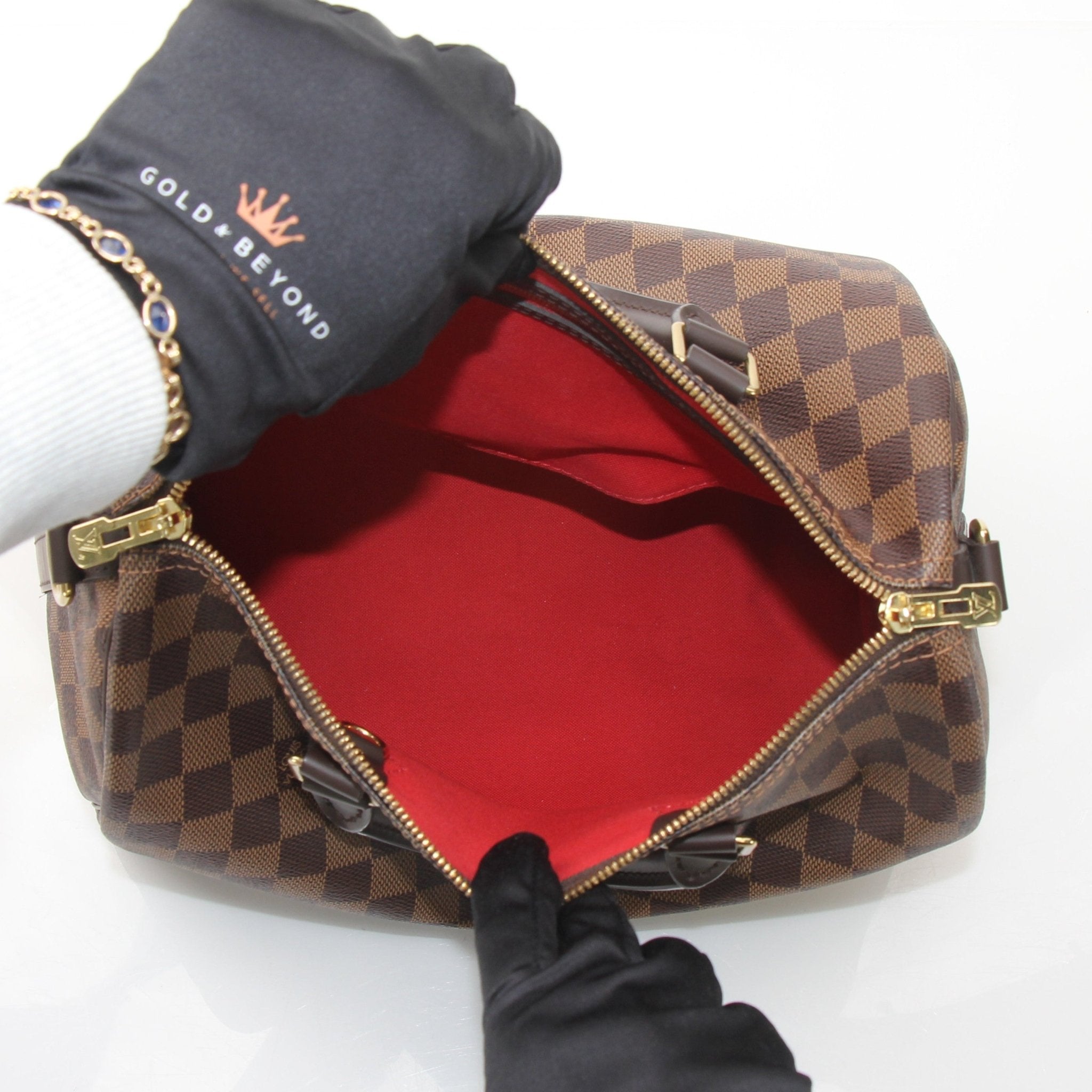 Louis Vuitton Speedy Bandouliere 30 handbag with gold hardware and monogram canvas, featuring a top handle and adjustable strap.