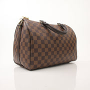 Louis Vuitton Speedy Bandouliere 30 handbag with classic monogram canvas and leather trim, shown with strap and top zipper.