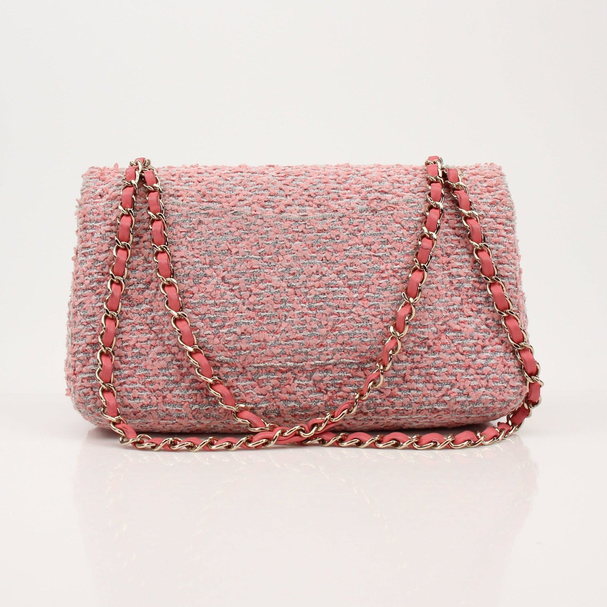 Pink Chanel Tweed Flap Handbag with gold chain strap and classic quilting, stylish and elegant accessory.