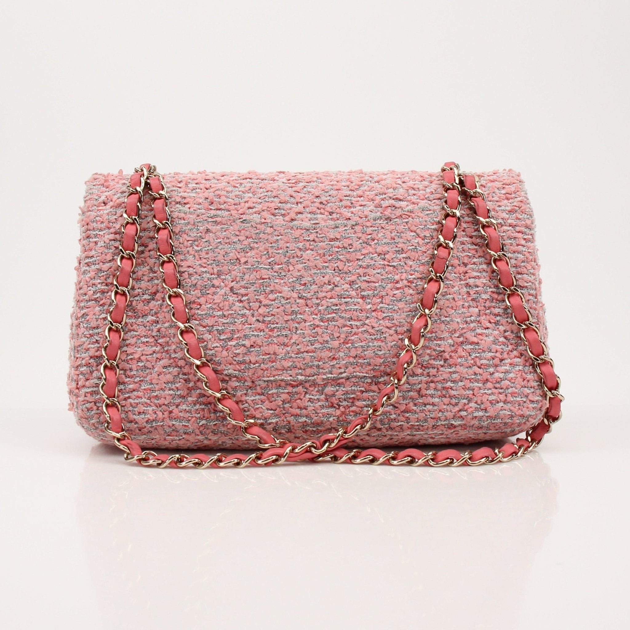 Pink Chanel Tweed Flap Handbag with gold chain strap and classic quilting, stylish and elegant accessory.