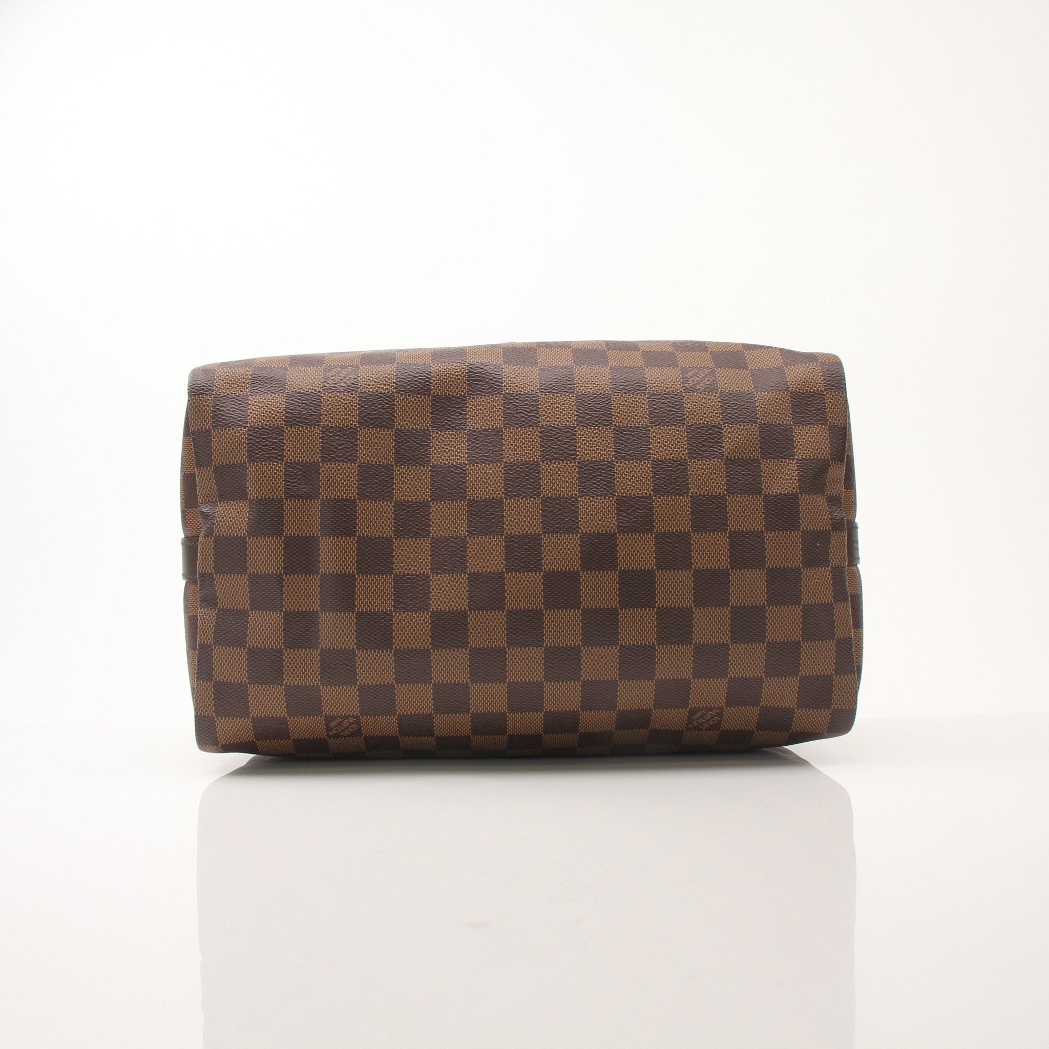 Louis Vuitton Speedy Bandouliere 30 handbag with gold-tone hardware and classic monogram canvas, carried by a model.