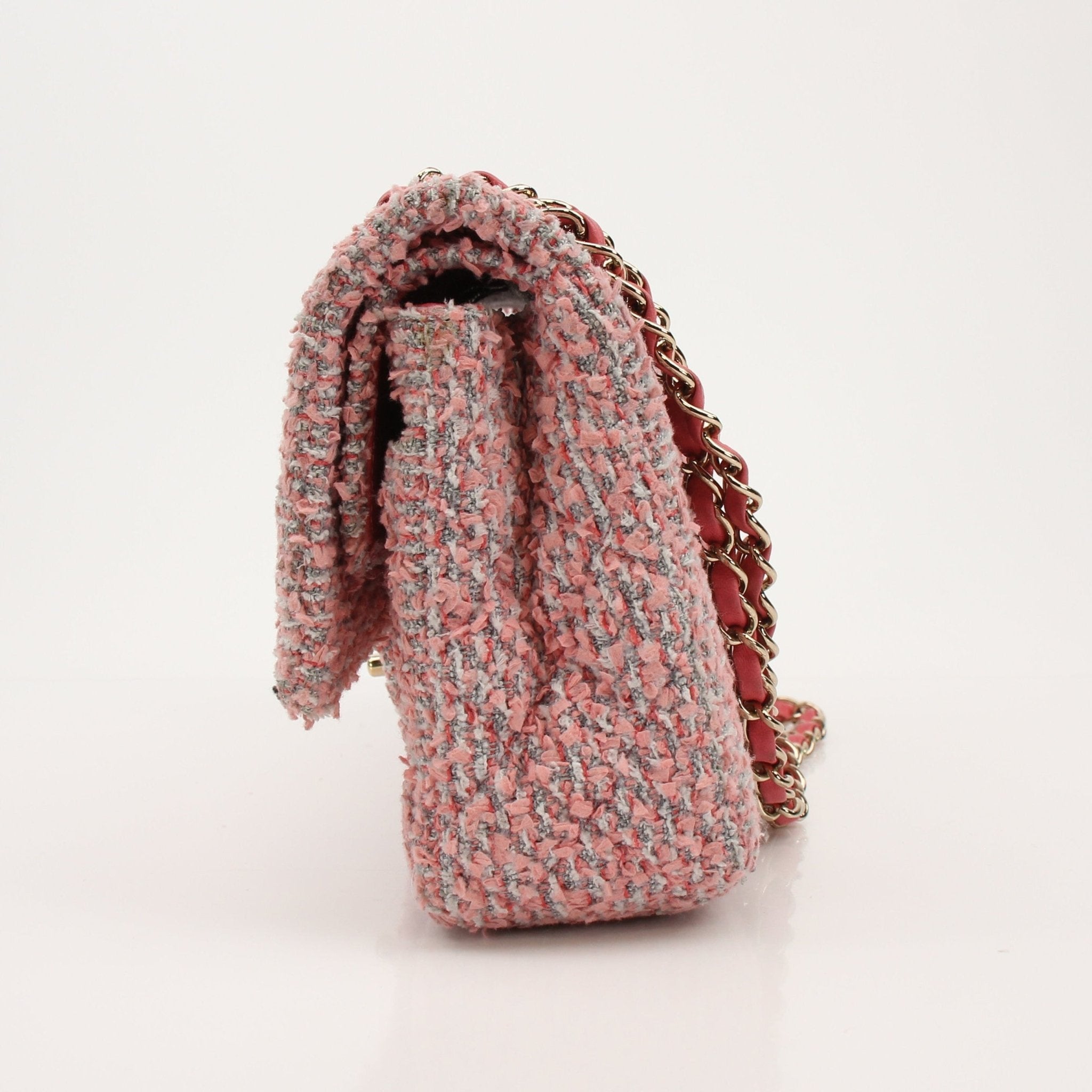Gold & Beyond Chanel pink tweed flap handbag with gold hardware and signature quilted design.