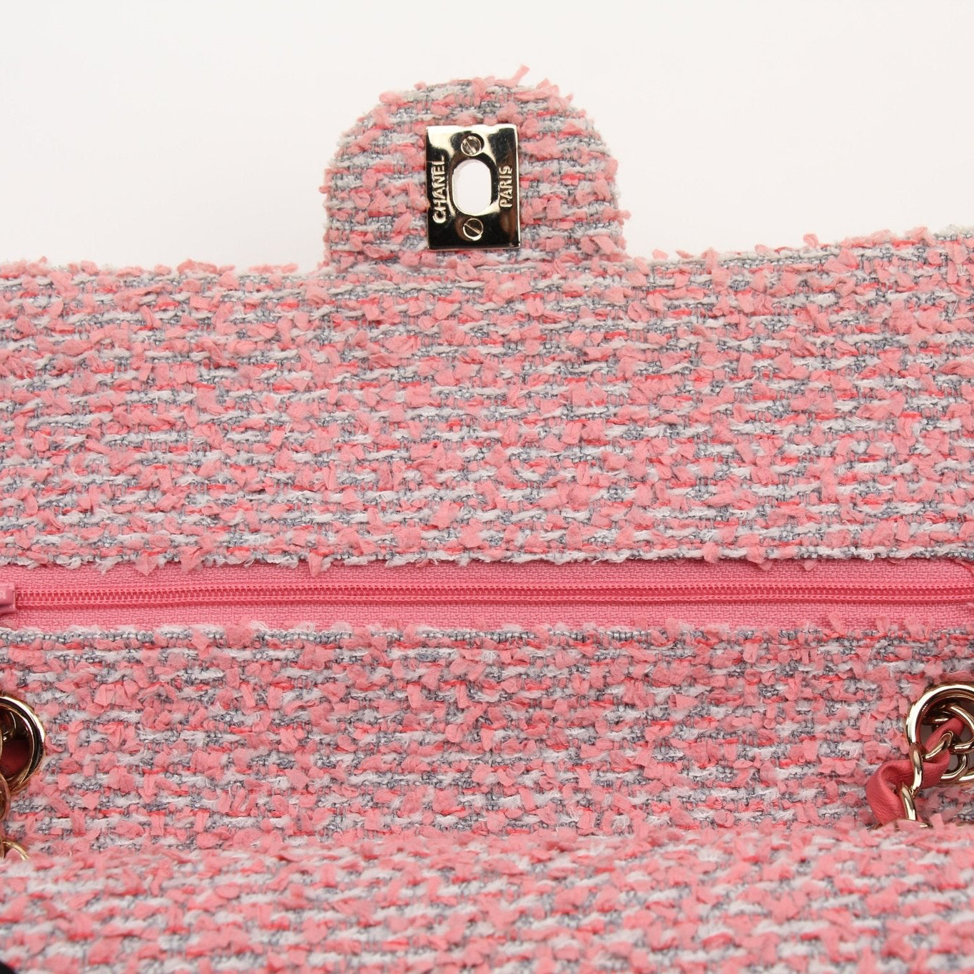 Pink Chanel Tweed Flap Handbag with gold accents, featuring classic design and textured fabric.