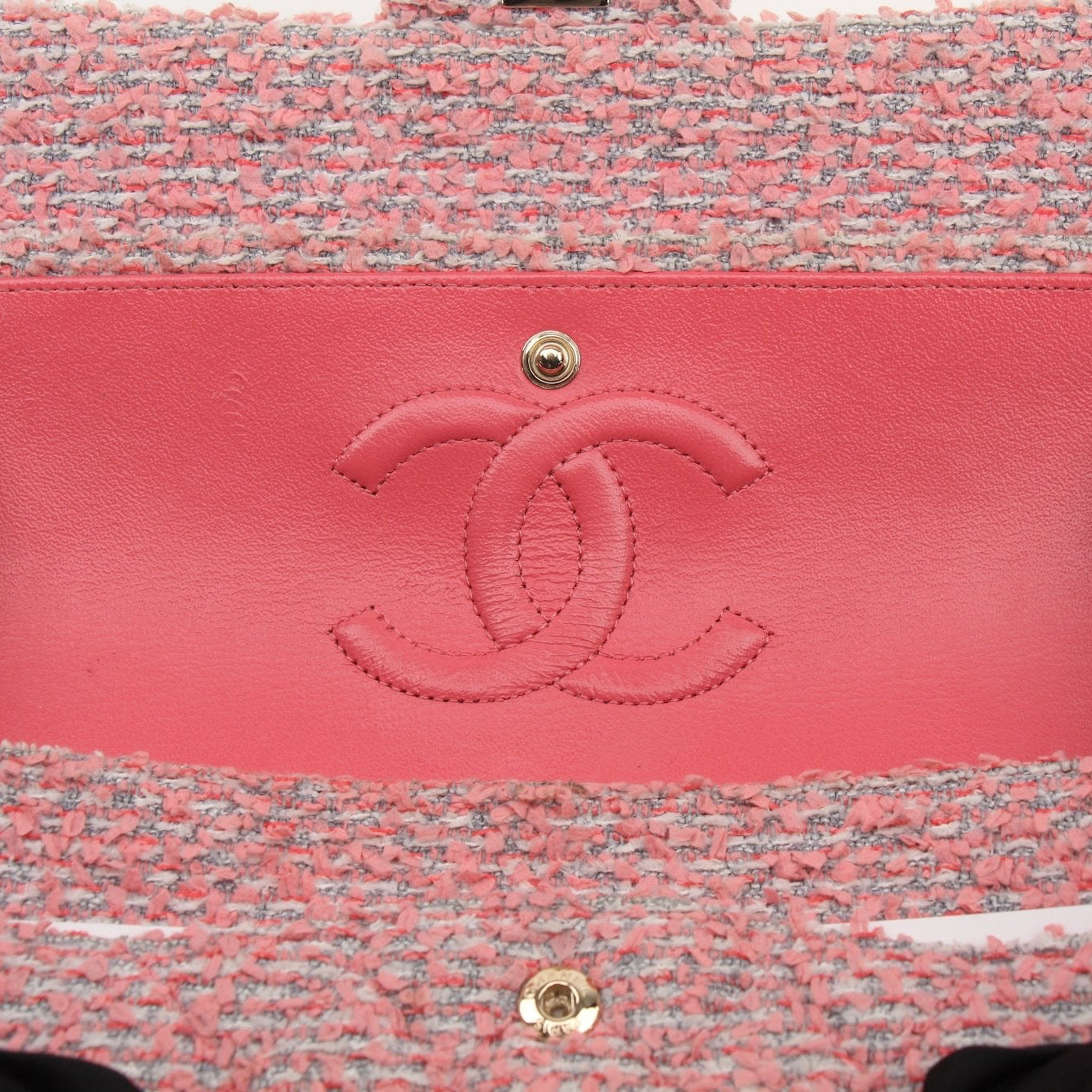 Pink Chanel Tweed Flap Handbag with gold accents, showcasing a classic elegant design and textured fabric.