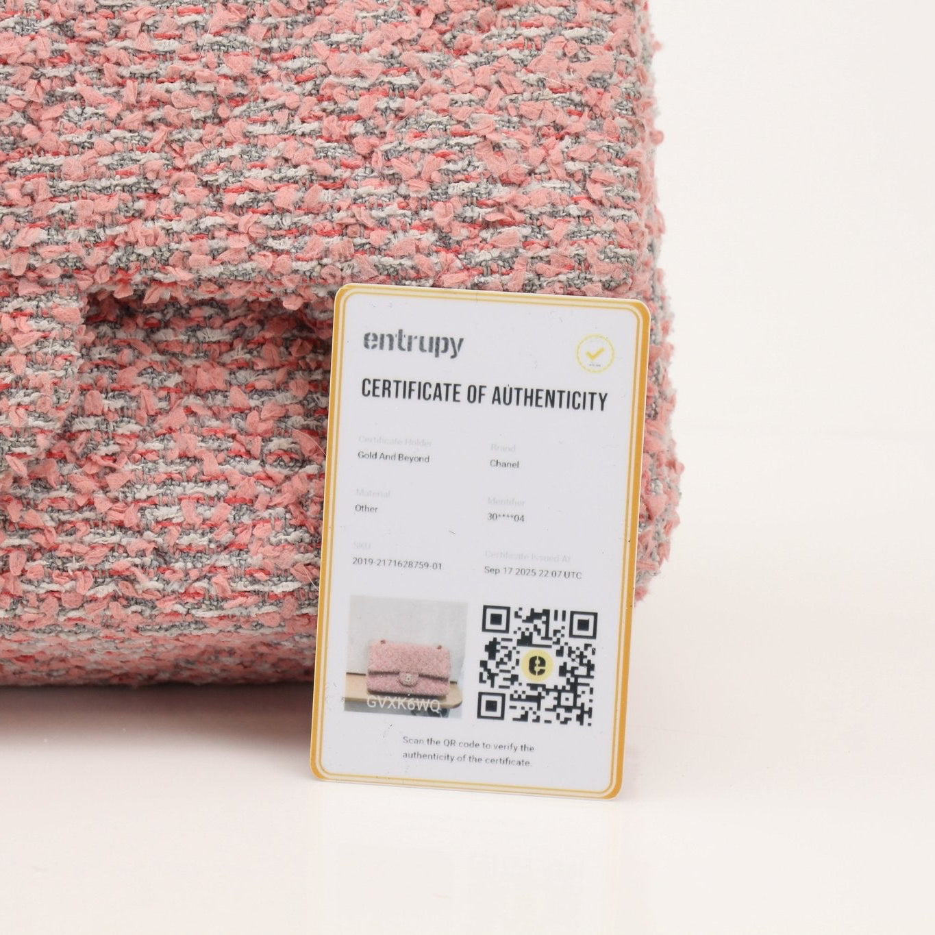 Gold & Beyond Chanel pink tweed flap handbag with gold chain strap and signature quilted design.