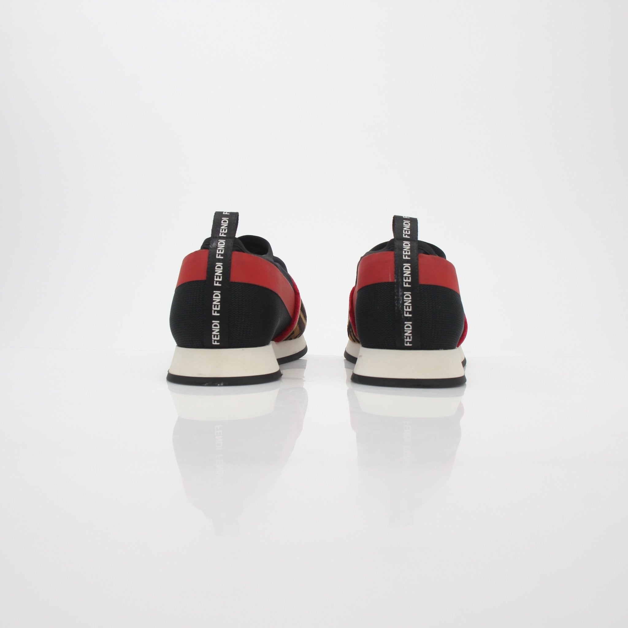 Black and red Fendi Zucca FF logo slip-on sneakers with stylish design, featuring Gold & Beyond branding on shoes.