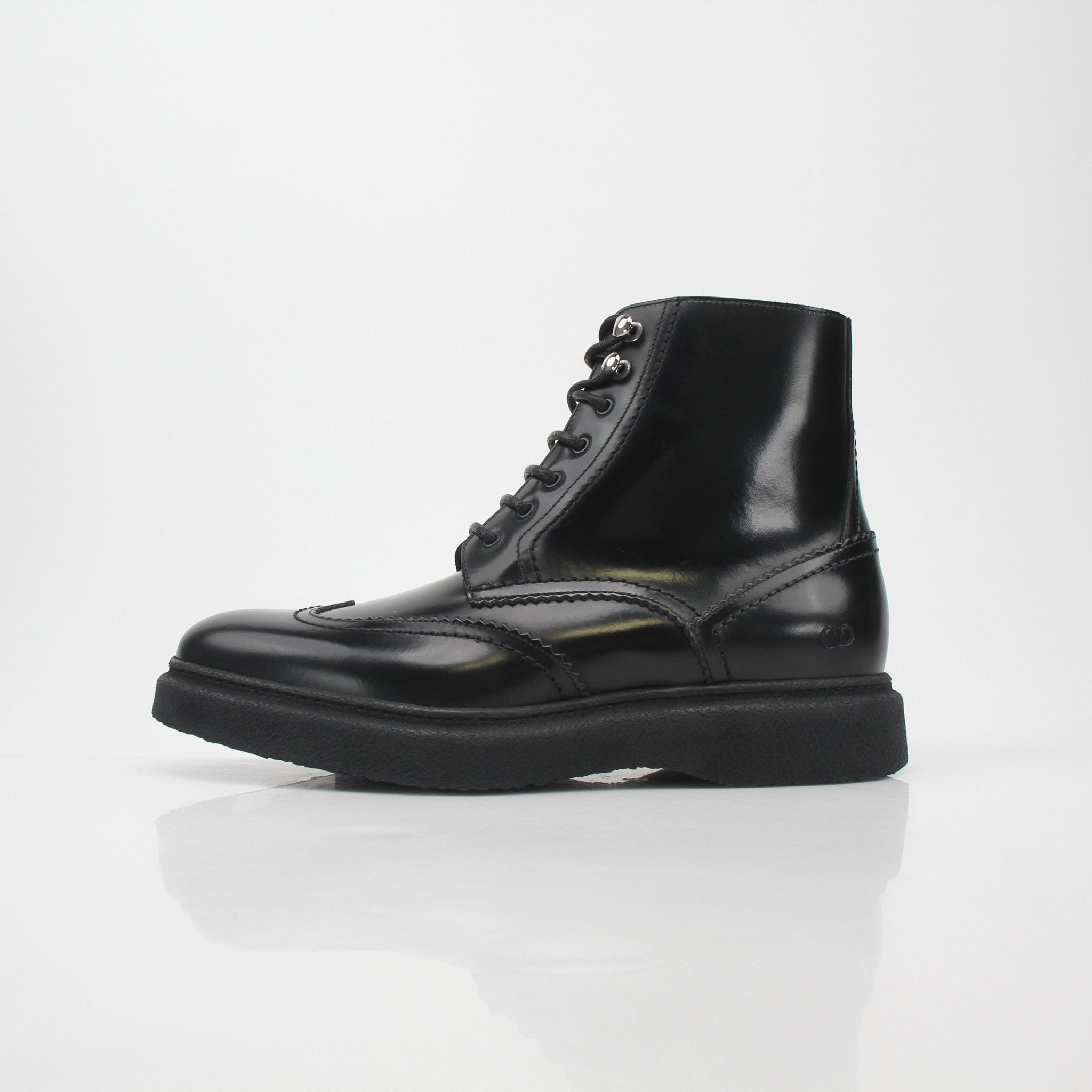 Christian Dior black leather wingtip combat ankle boots, stylish shoes with detailed wingtip design and sturdy sole.