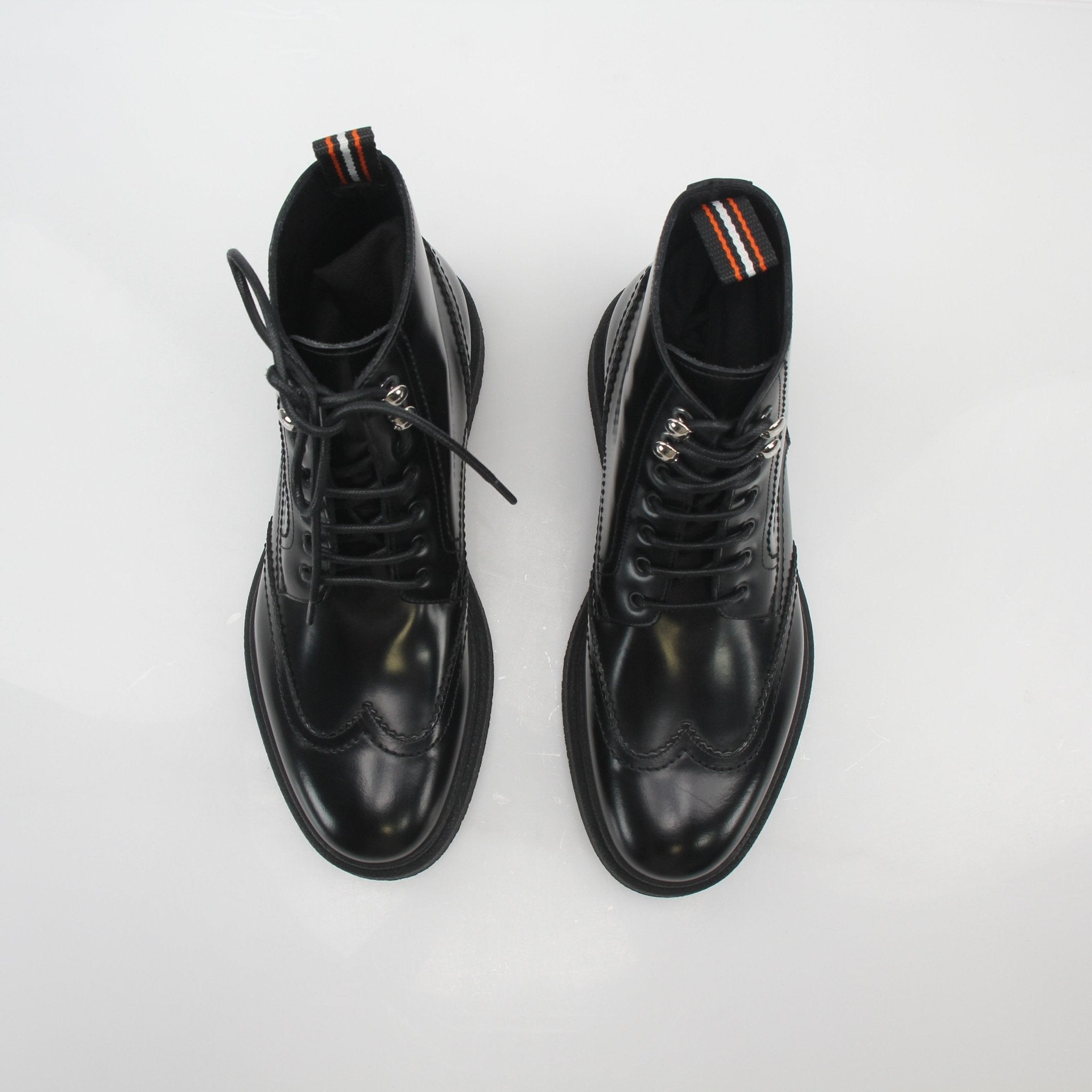 Christian Dior black leather wingtip combat ankle boots with laces and rugged sole, stylish shoes by Gold & Beyond