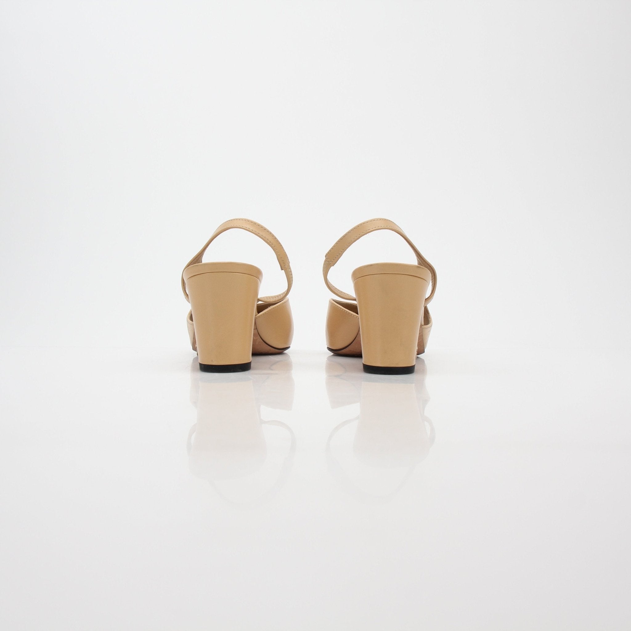 Gold & Beyond beige and black cap-toe slingback pumps with heels, featuring a classic design and elegant style.