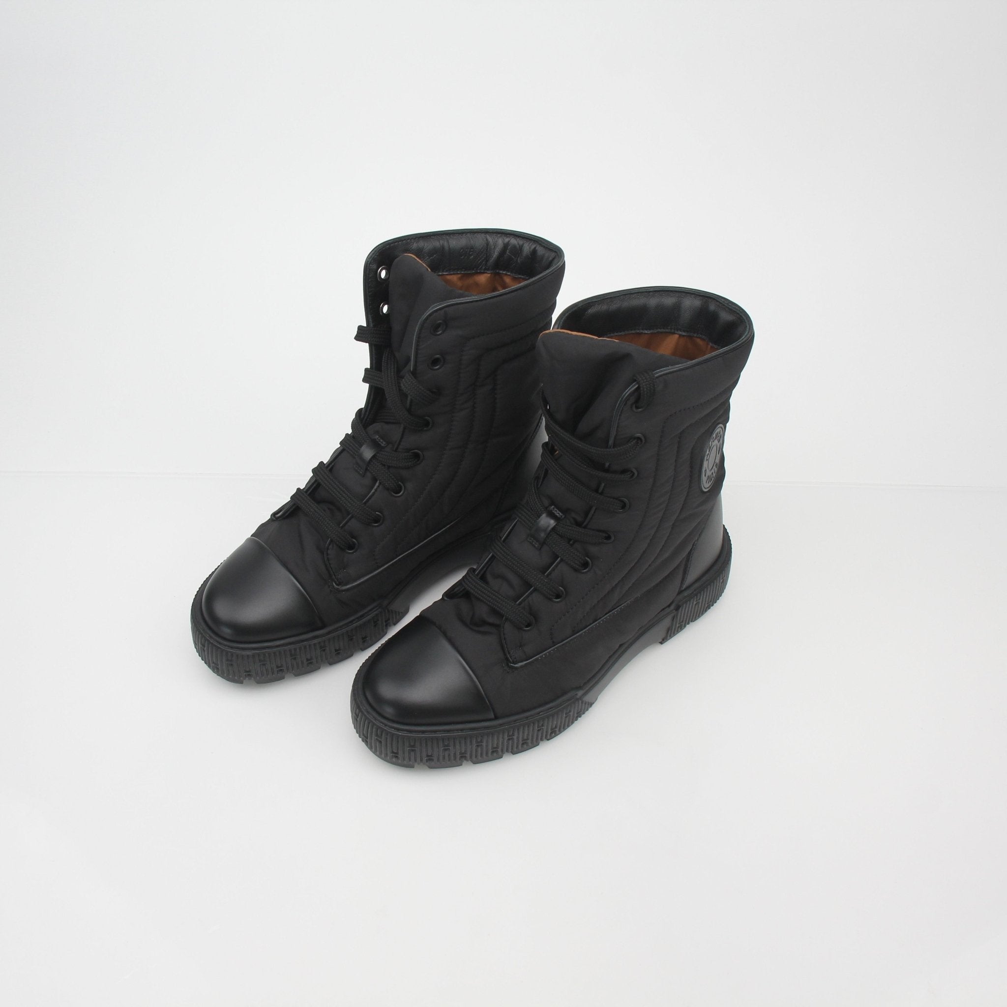 Hermès black lace-up ankle boots by Gold & Beyond, featuring fresh leather and stylish design, shown from a front angle.