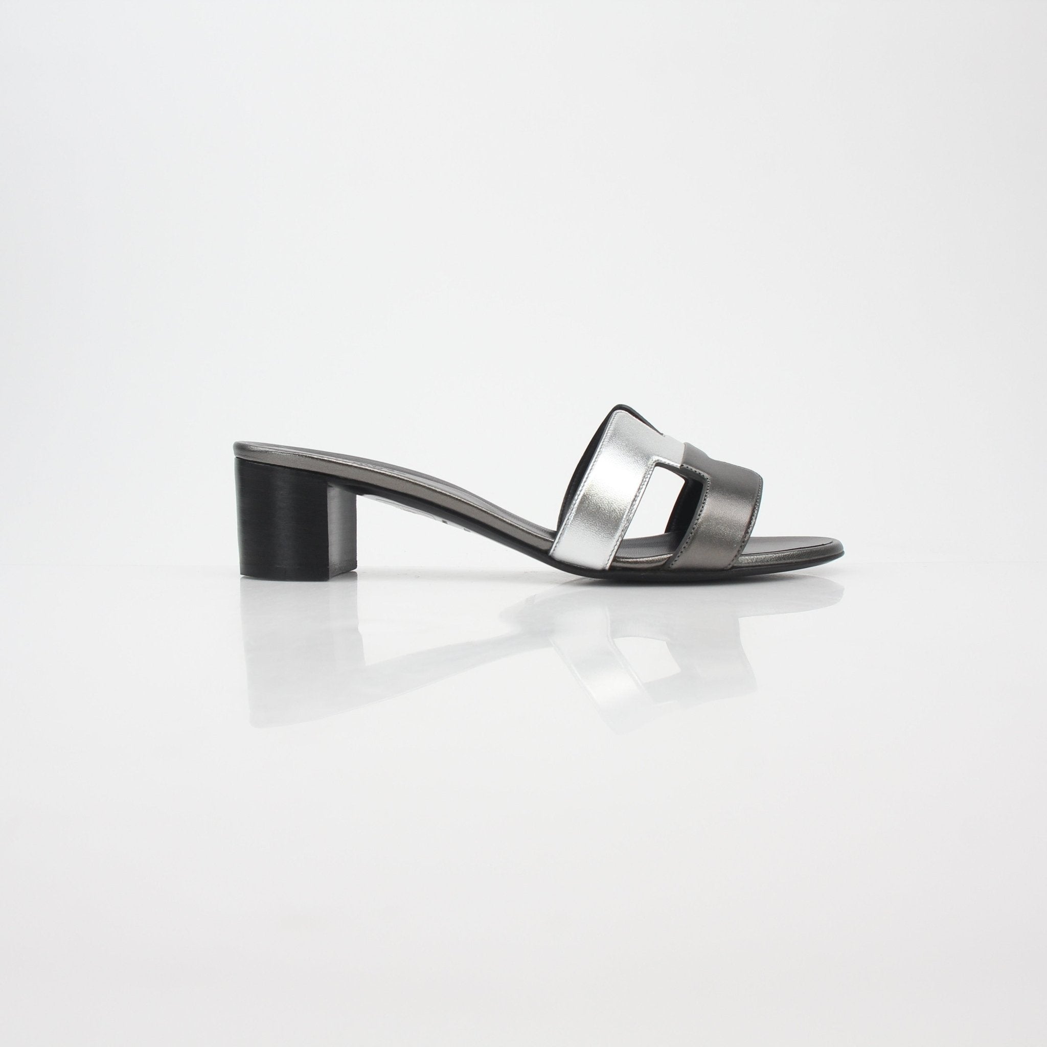Hermès Metallic Silver Oasis sandals by Gold & Beyond, showcasing stylish silver shoes with metallic finish and open-toe design.