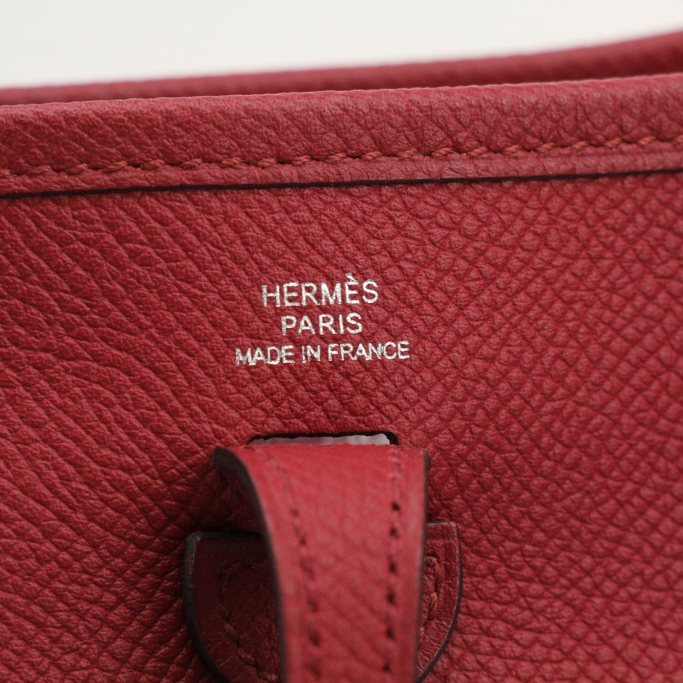 Hermès Evelyne Mini handbag in leather with gold hardware, featuring adjustable strap and signature logo for stylish carry.