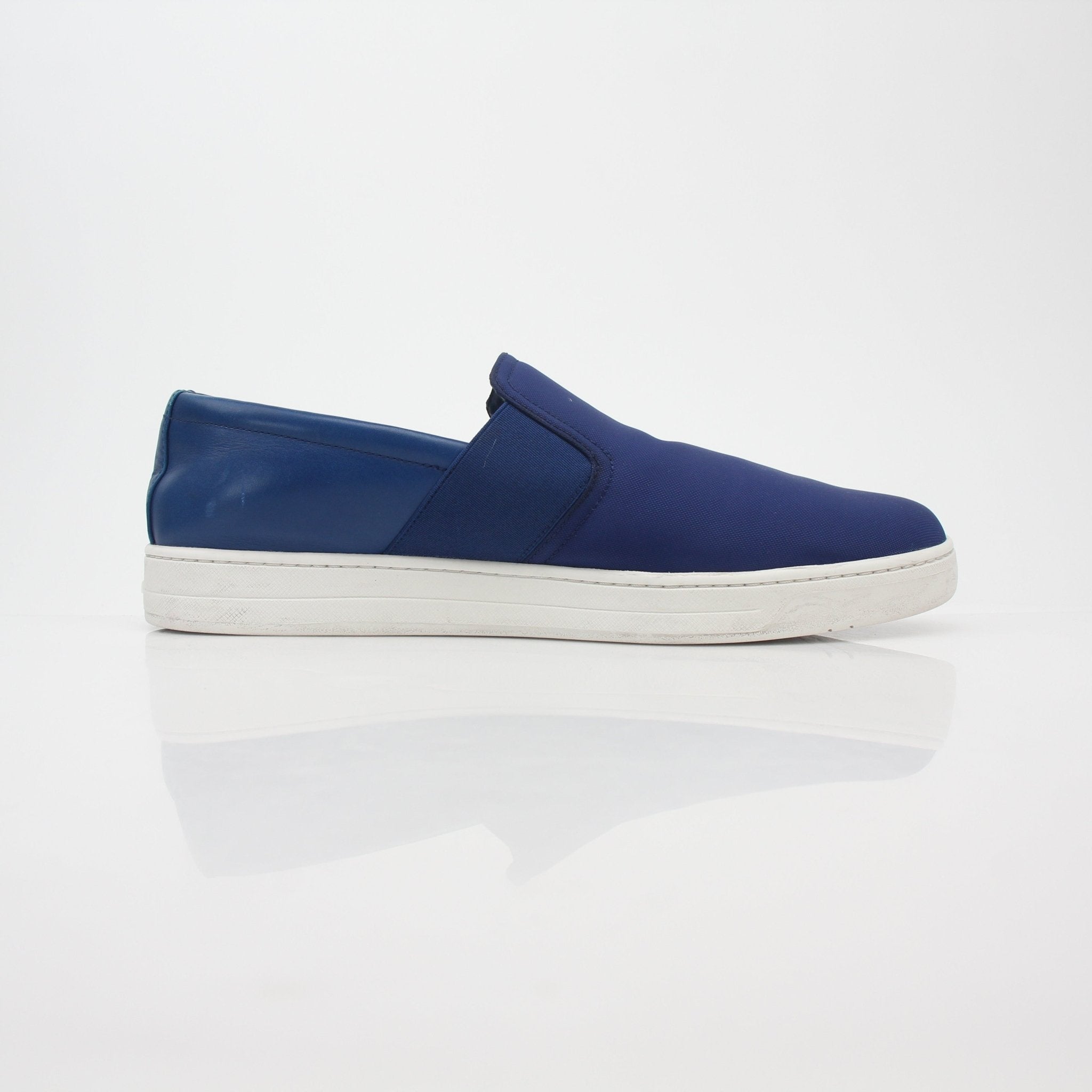 Prada blue nylon slip-on sneakers with white soles and minimal branding, designed for casual and sporty wear.