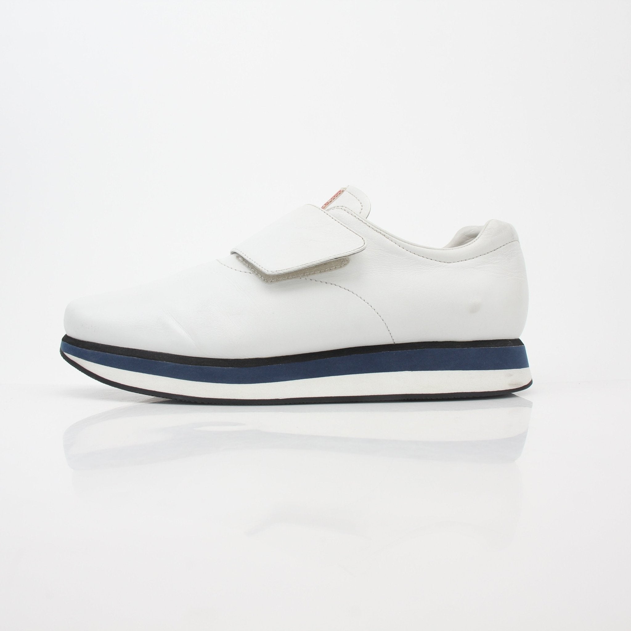 Prada white leather platform sneakers with chunky soles and laced closure, displayed on a white background.