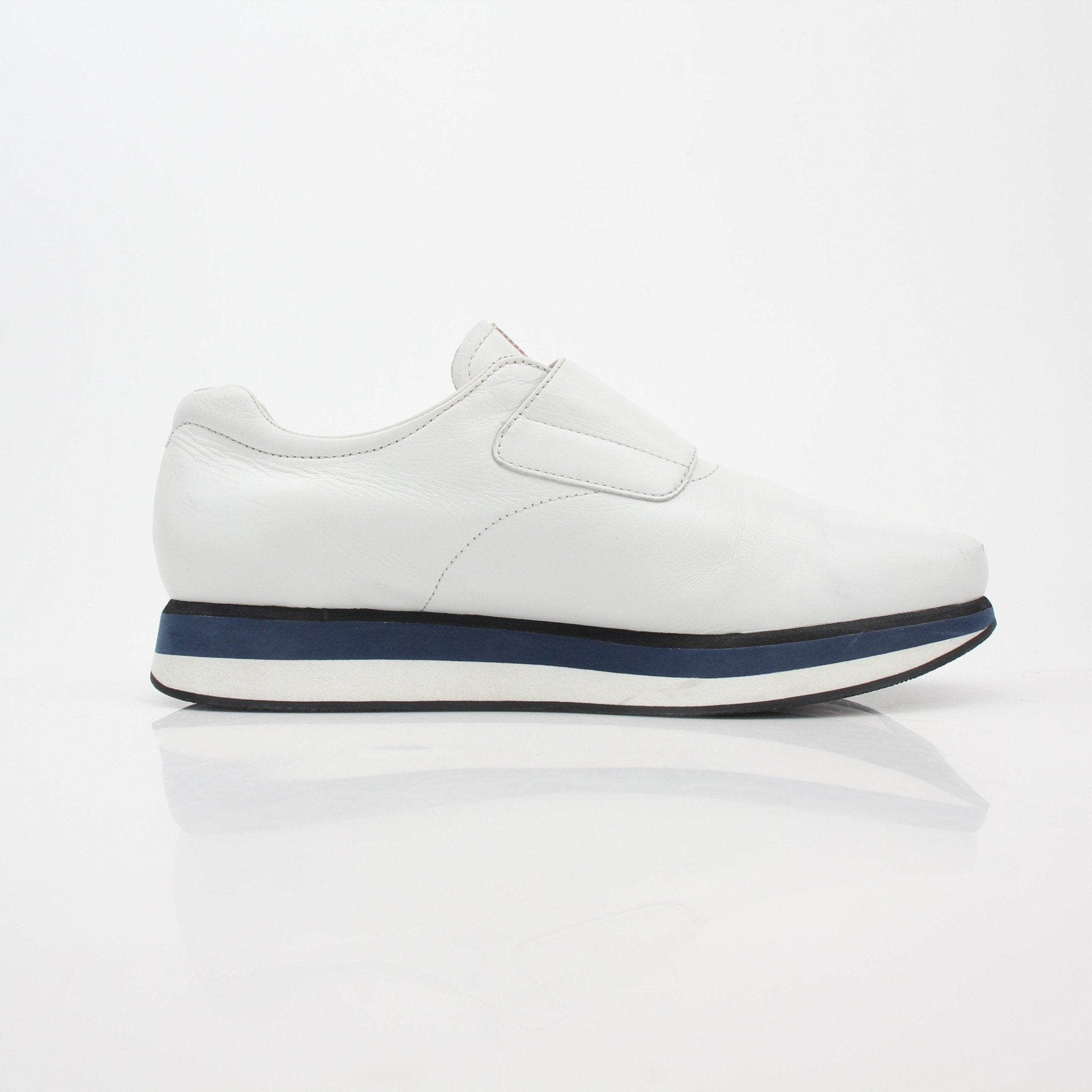 Prada white leather platform sneakers with chunky soles and minimalist design, showcasing the stylish shoes from Gold & Beyond.