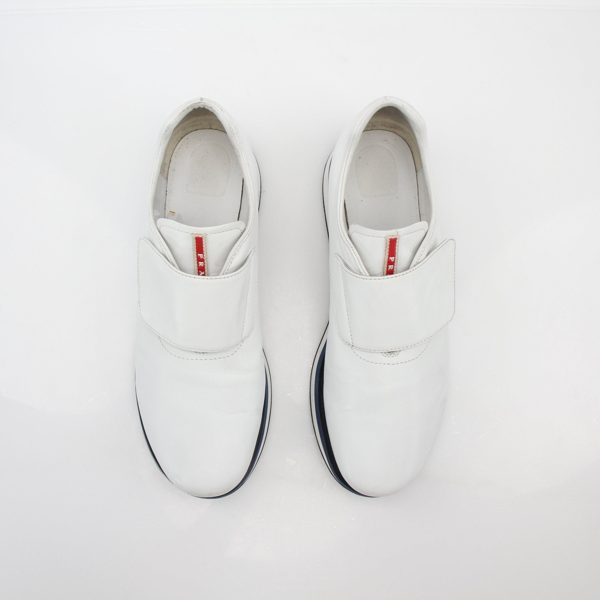 Prada white leather platform sneakers with chunky soles, stylish shoes by Gold & Beyond, shown on a clean background.
