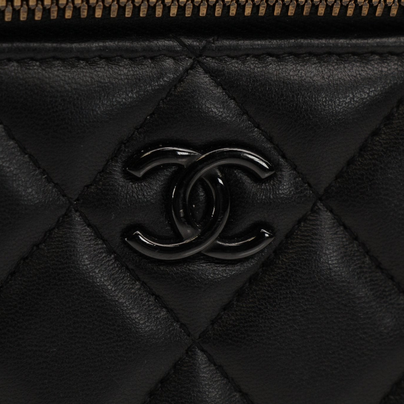 Gold & Beyond Chanel Vanity Bag for travel, featuring a sleek design with multiple compartments and elegant gold accents.