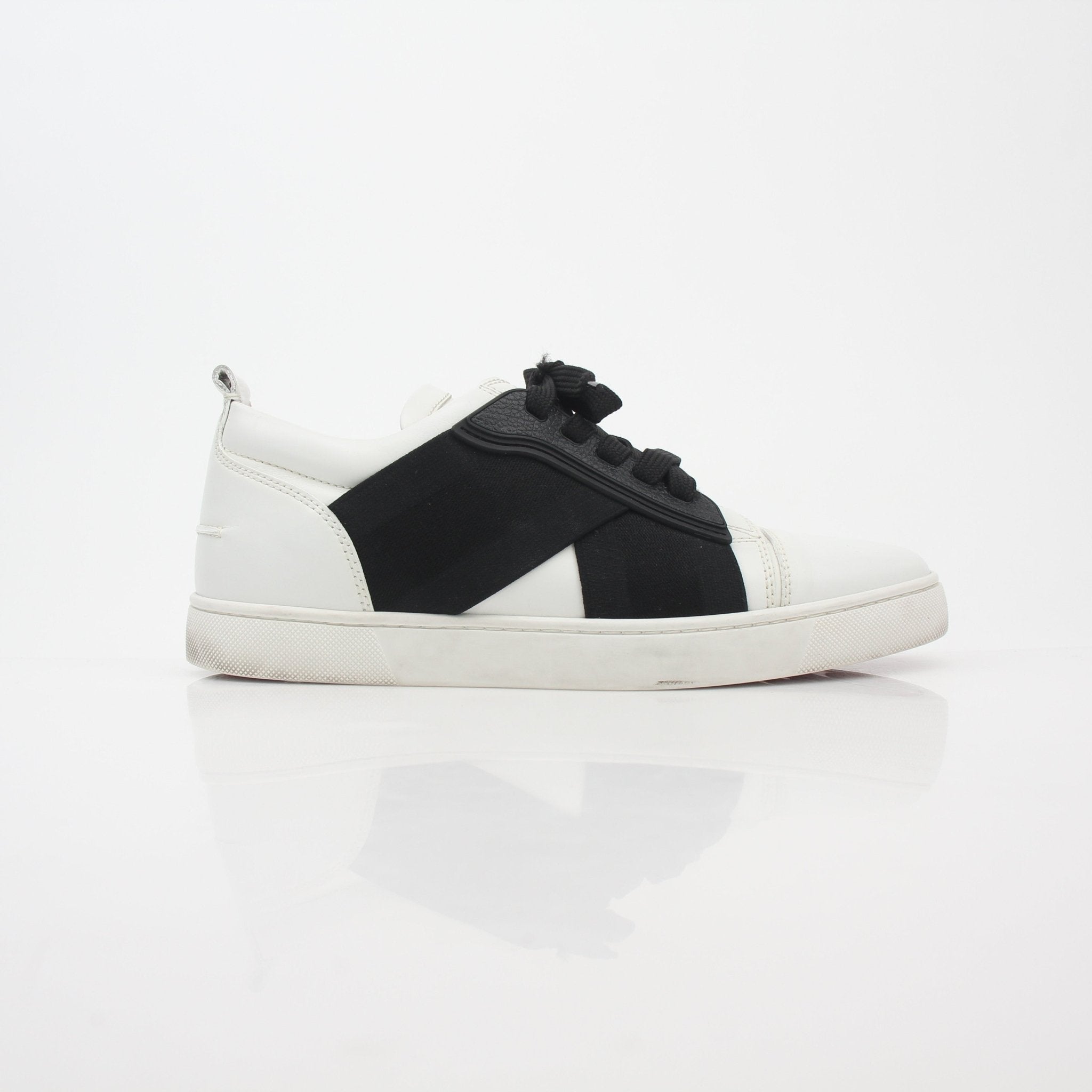 White and black Christian Louboutin Elastikid sneakers featuring sleek design, displayed on a plain background.
