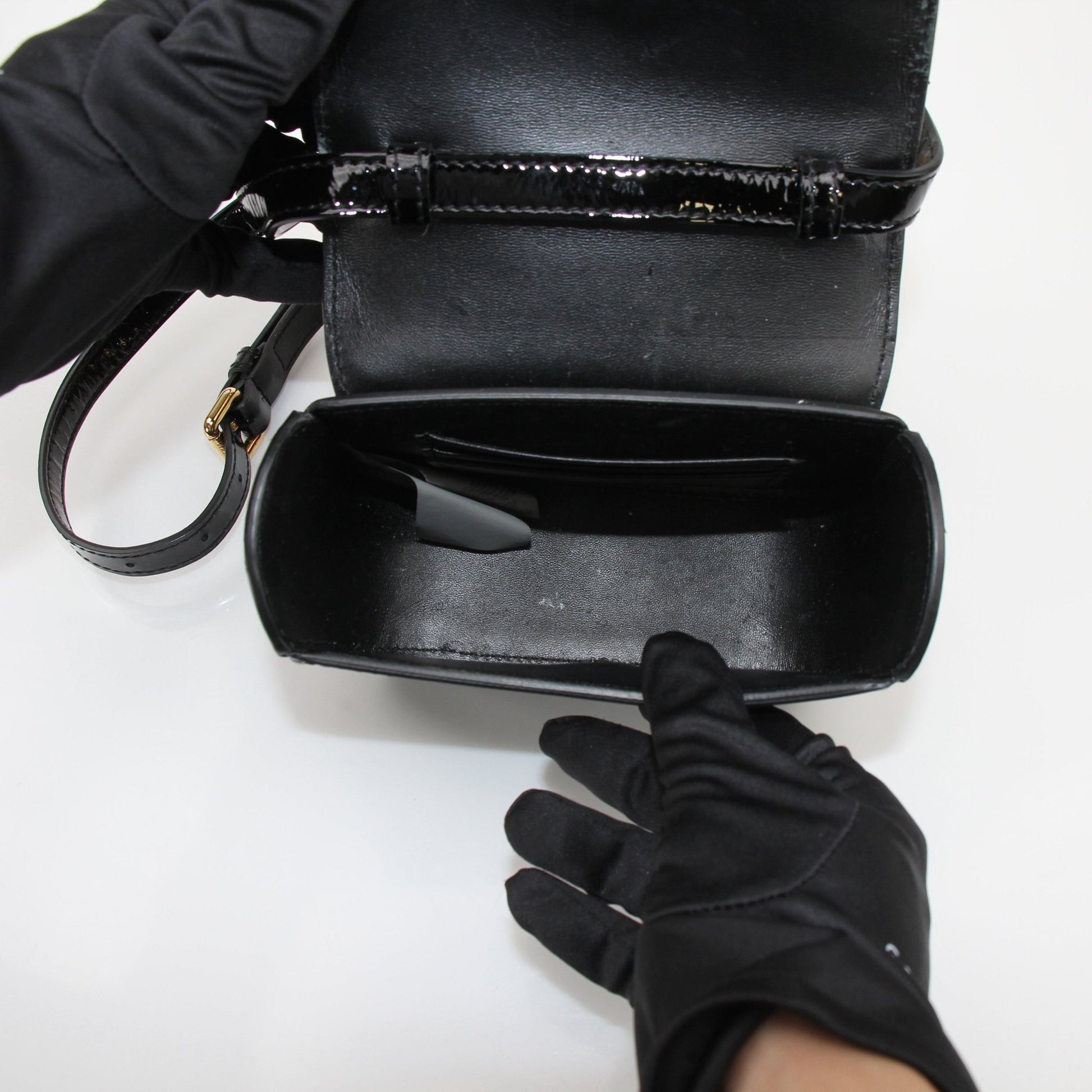 Gold & Beyond Versace La Medusa Mini Handbag with signature logo and elegant design, featuring gold-tone hardware and black leather.