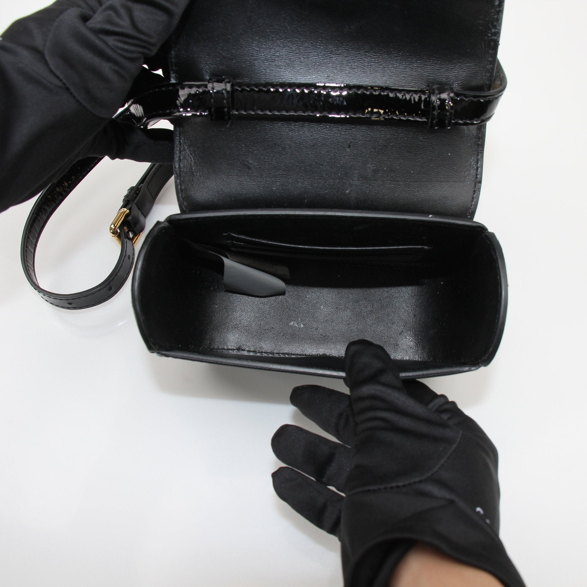 Gold & Beyond Versace La Medusa Mini Handbag with signature logo and elegant design, featuring gold-tone hardware and black leather.