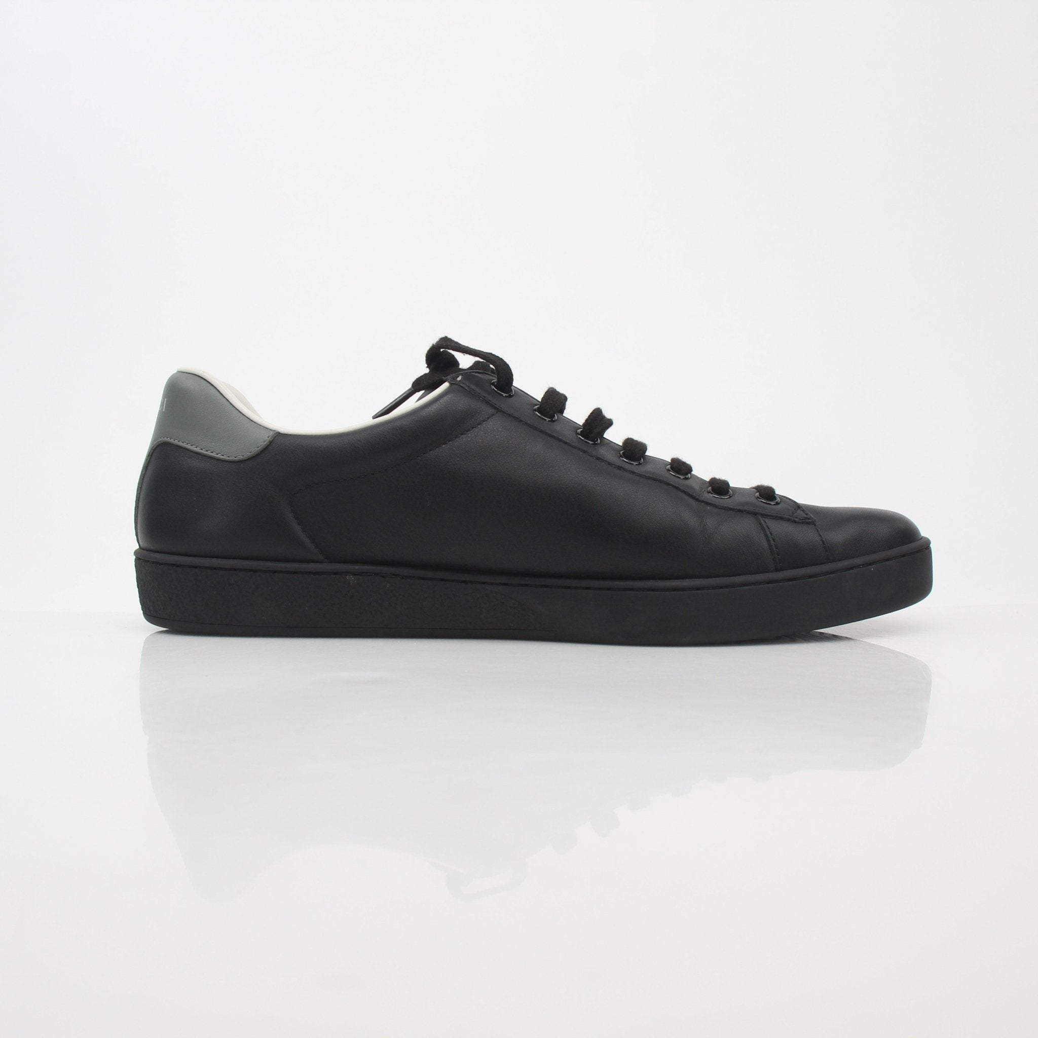 Gucci Black Ace perforated leather sneakers with interlocking G logo, featuring stylish design and classic sneaker silhouette.