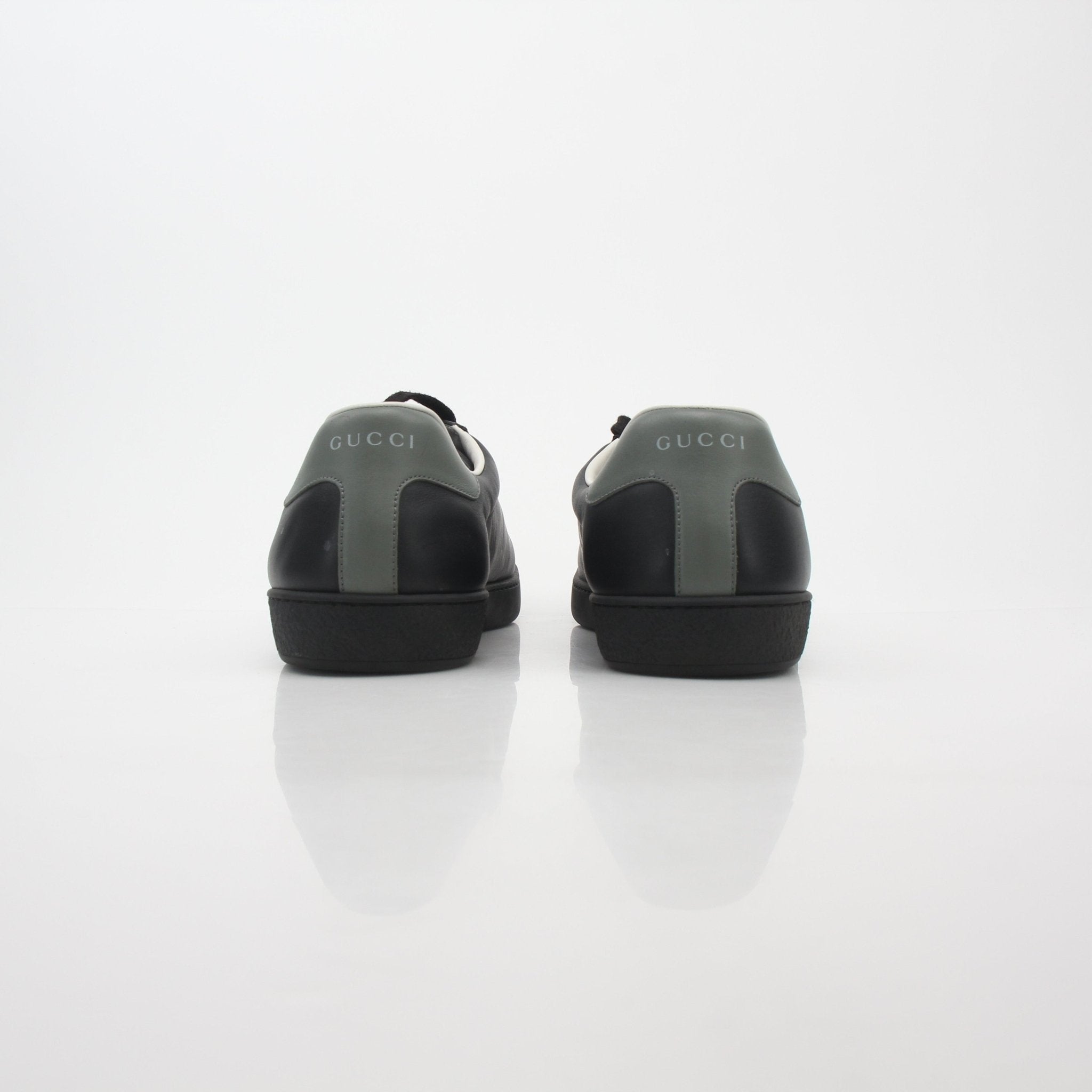 Gucci Black Ace perforated leather sneakers with interlocking G design, featuring a sleek, stylish shoe profile.