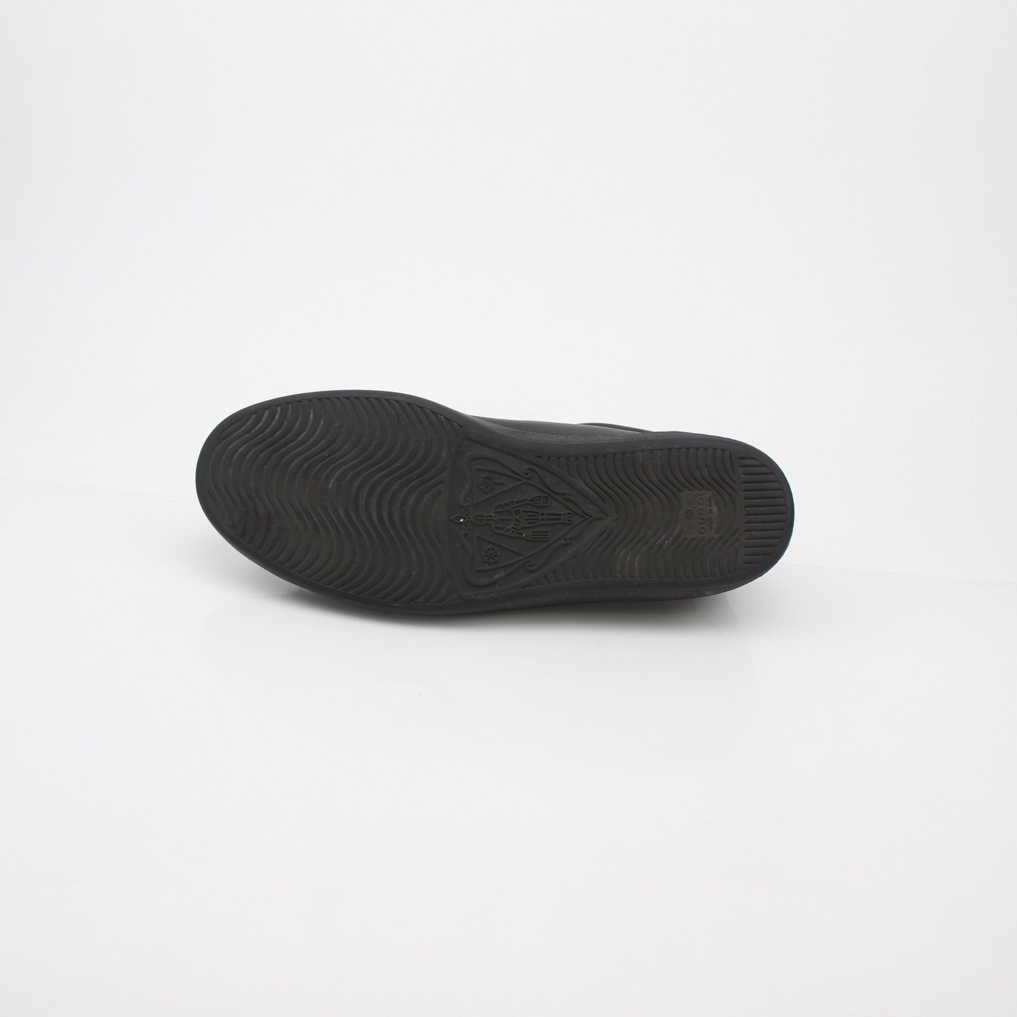 Gucci Black Ace perforated leather sneakers with interlocking G logo, stylish shoes with white rubber soles and black laces.