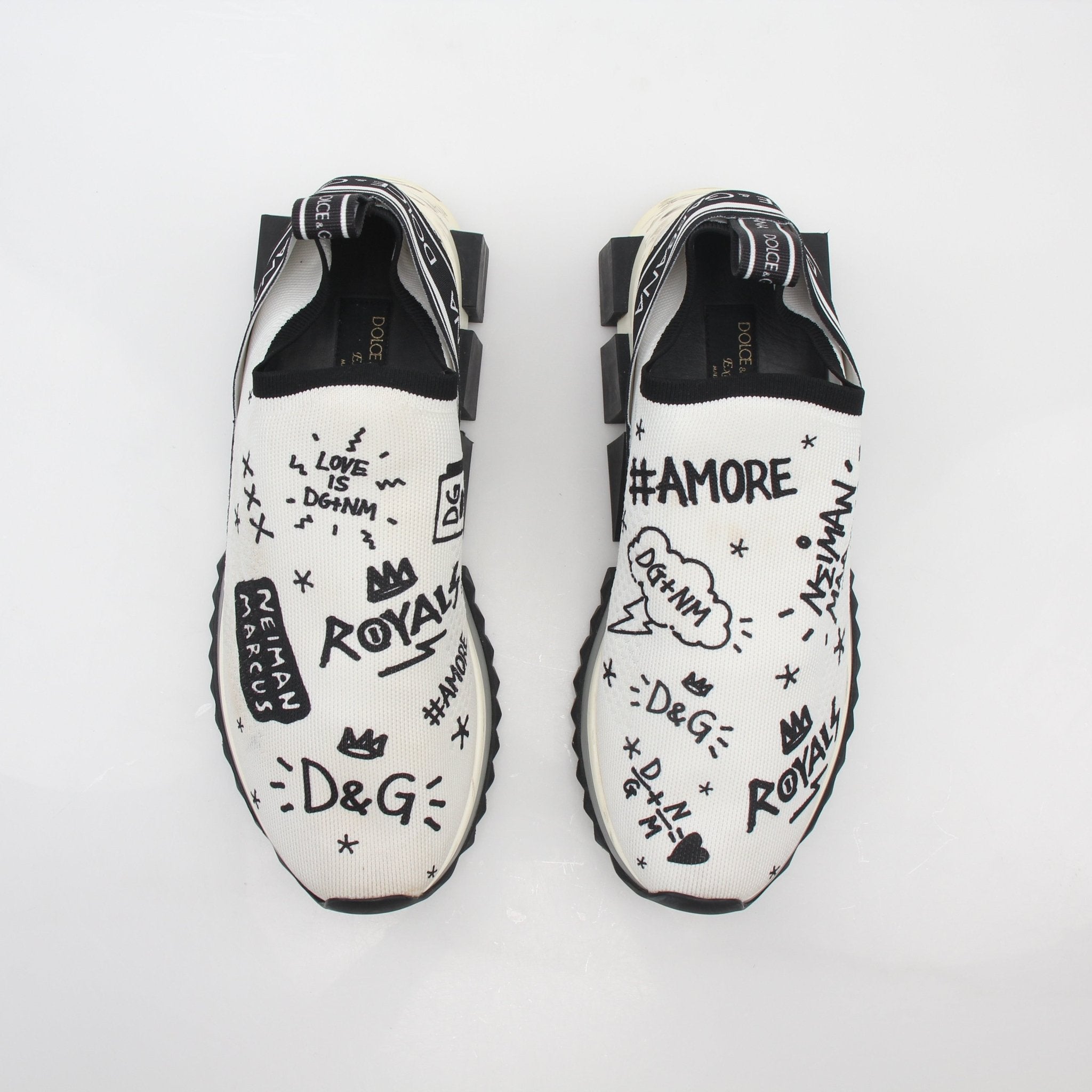 White Dolce & Gabbana Sorrento graffiti print sneakers with colorful design and lace-up closure, from Gold & Beyond.